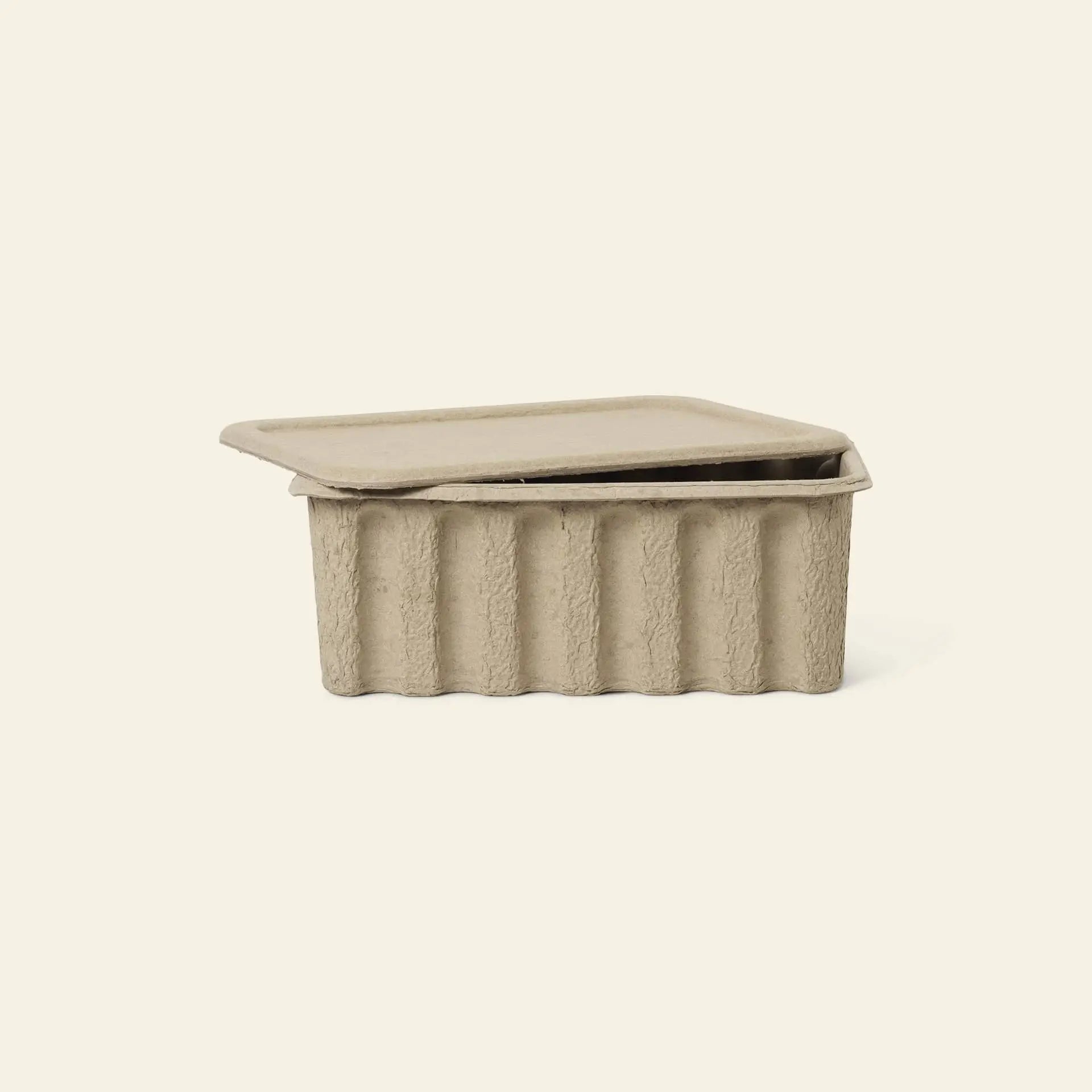 The ferm LIVING Paper Pulp Box Large, Set of 2, features beige, rectangular recycled paper pulp containers with matching partially open lids—an eco-friendly storage solution by ferm LIVING shown on a plain light background.