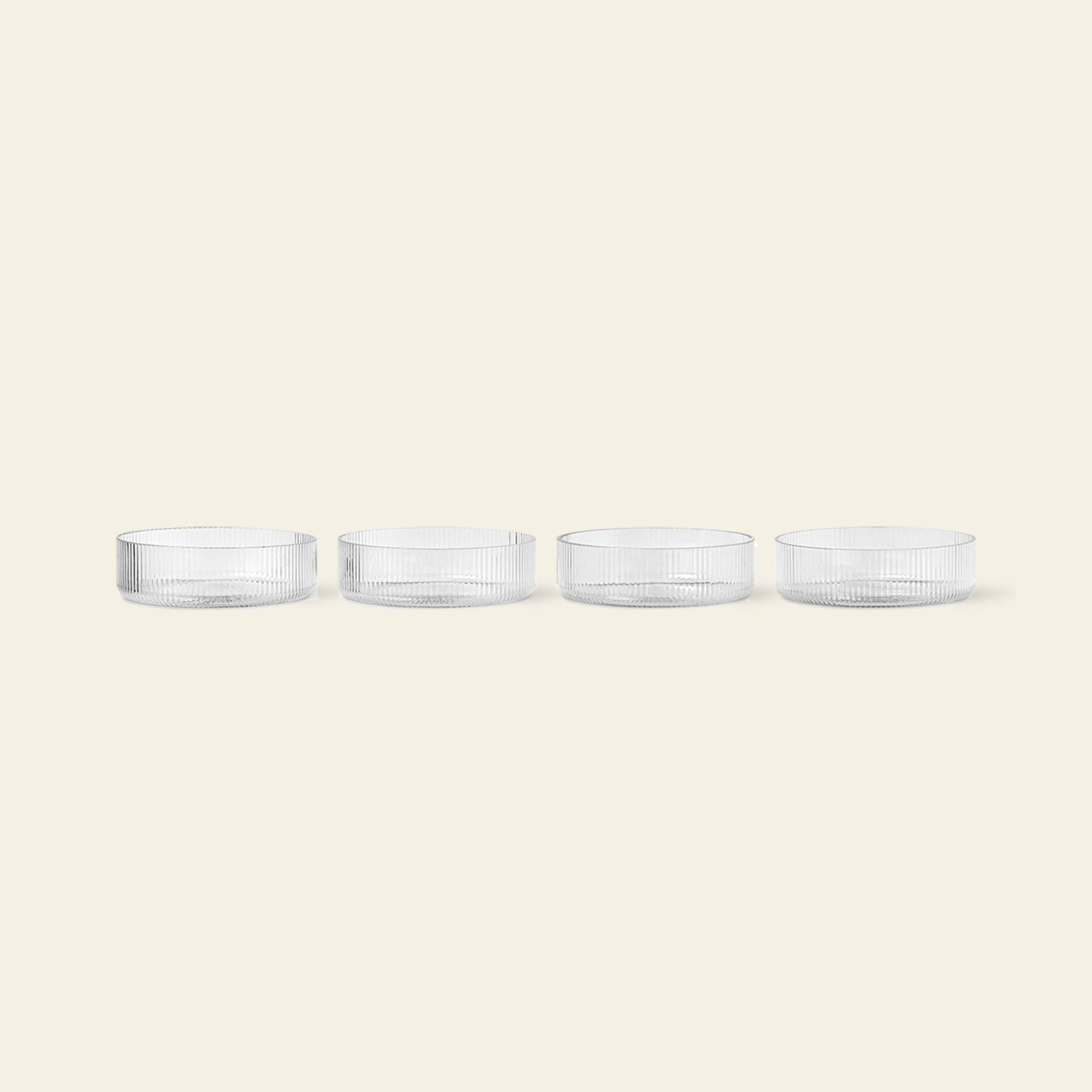 The ferm LIVING Ripple Serving Bowls, Set of 4, crafted from mouth-blown glass, feature a textured surface and elegant design. Each clear bowl is displayed in a row on a light beige background.
