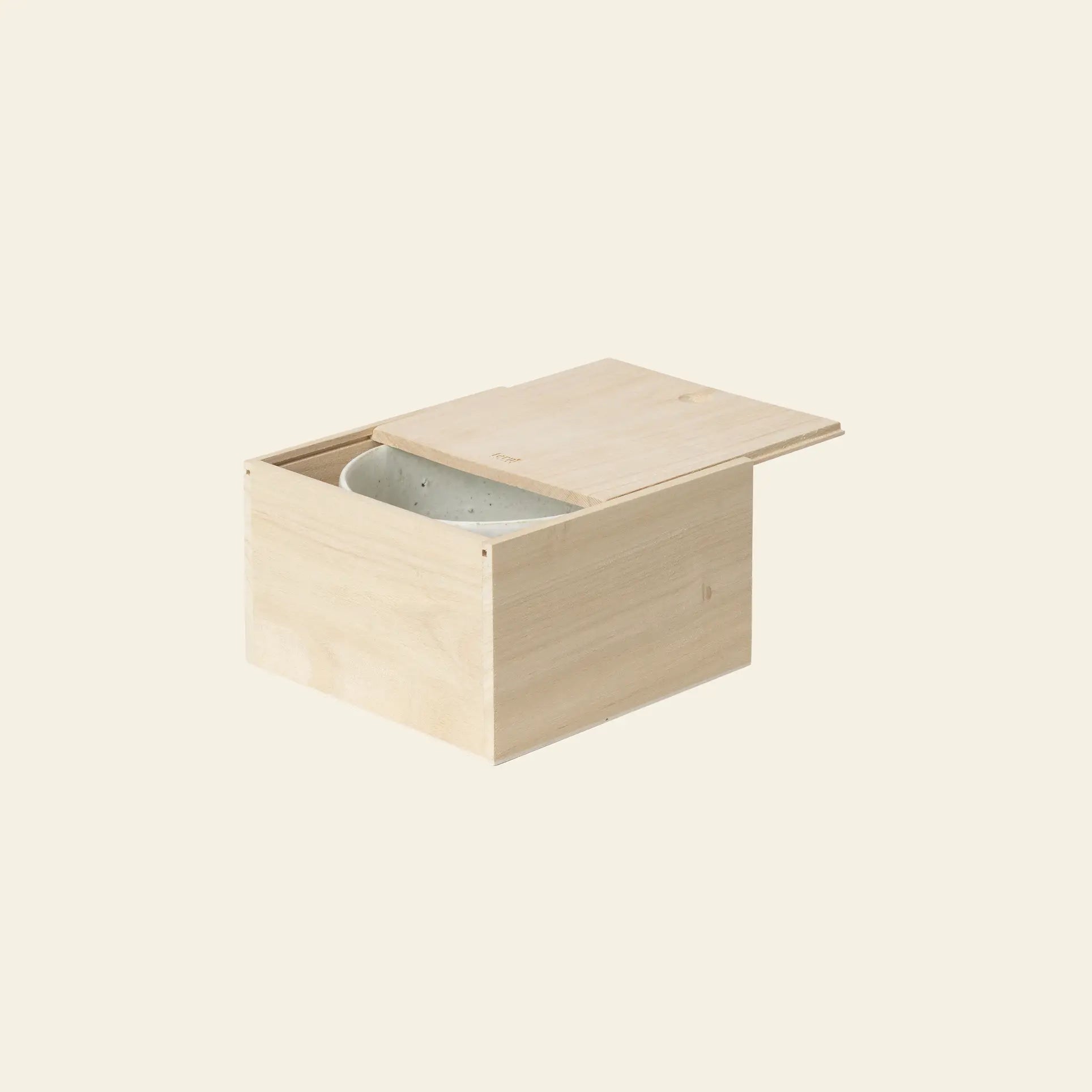 A light wooden box with a sliding lid, partially open to reveal the ferm LIVING Serena Bowl, 12.5cm inside, set against a plain off-white background.