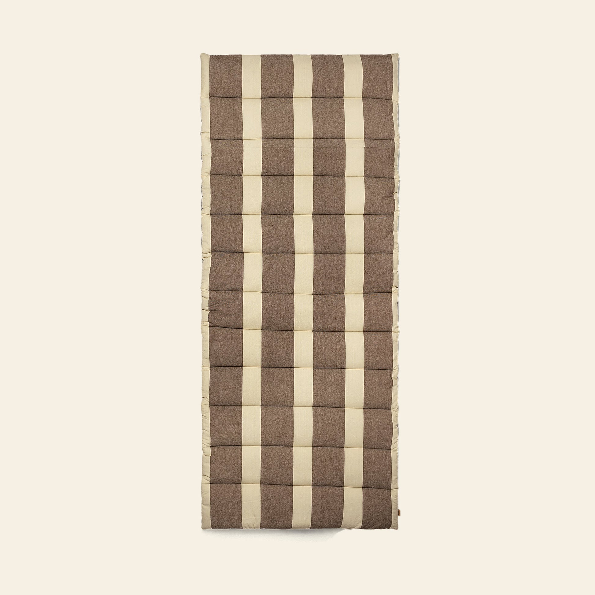 The ferm LIVING Strand Quilted Mattress, rectangular and padded, features a brown and beige plaid pattern in organic cotton, displayed against a plain light background.
