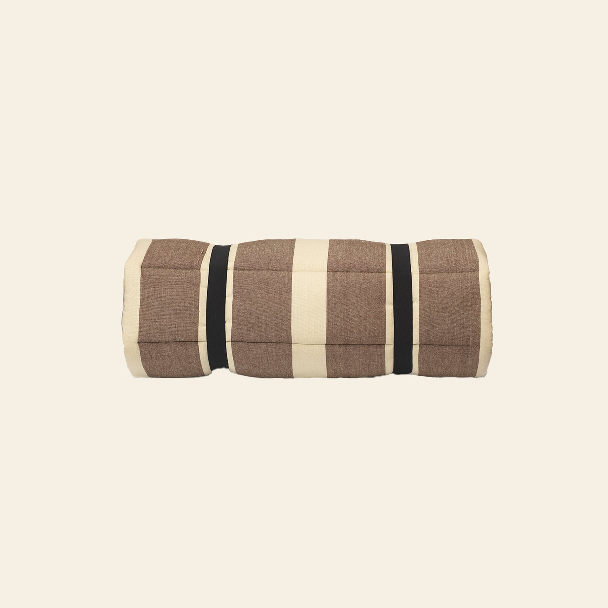 The ferm LIVING Strand Quilted Mattress by ferm LIVING is a rolled-up, brown and beige plaid blanket made from recycled polyester, secured with two black straps and displayed against a plain cream background.