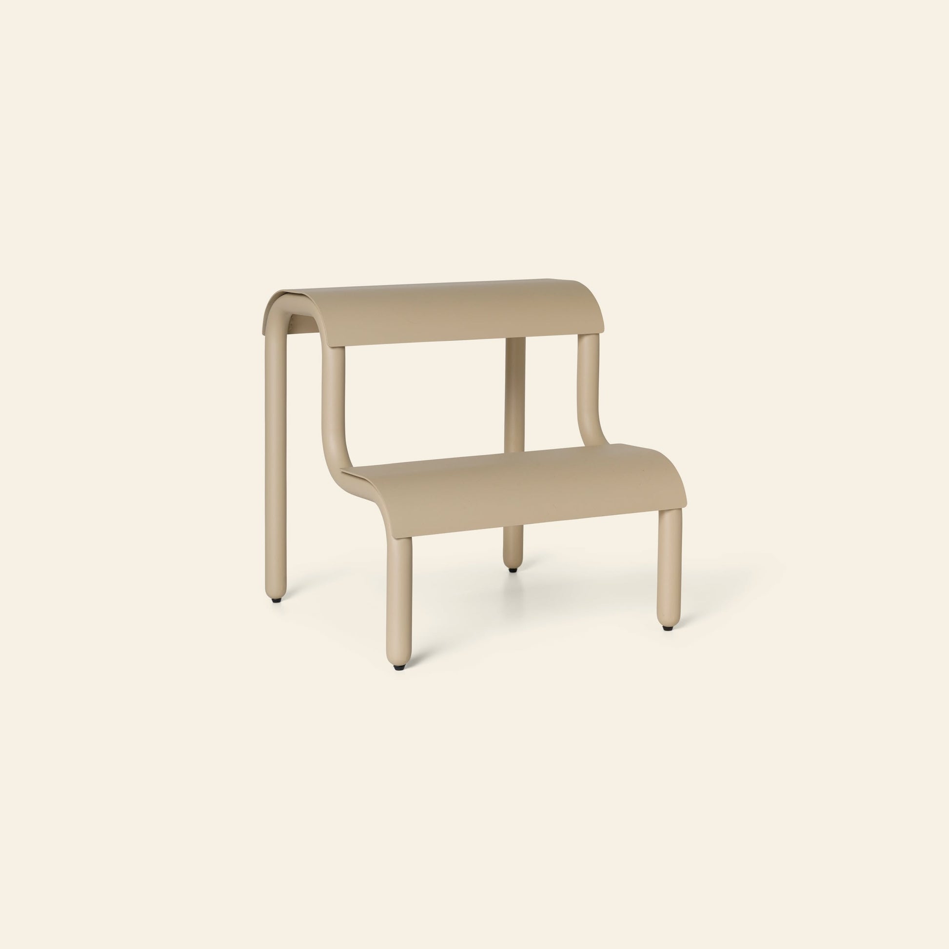 The ferm LIVING Up Step Stool by ferm LIVING is a modern beige step stool with rounded edges and a subtly textured surface, standing on four legs against an off-white background.