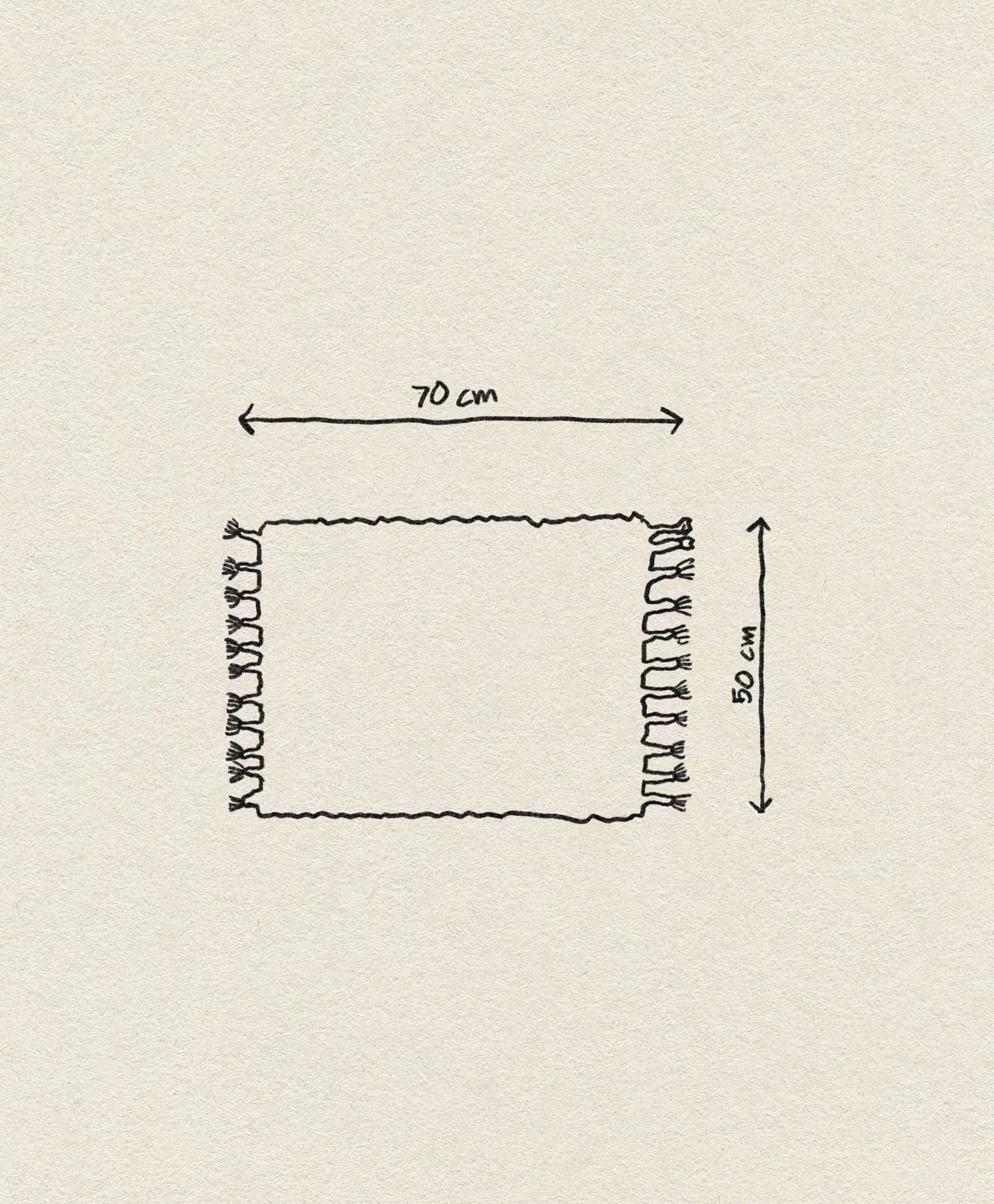 The ferm LIVING Amass Long Pile Mat by ferm LIVING is a hand-drawn rectangular rug, 70 cm wide and 50 cm high, with tassels on both sides. Two double-headed arrows show the size, and the background is off-white.