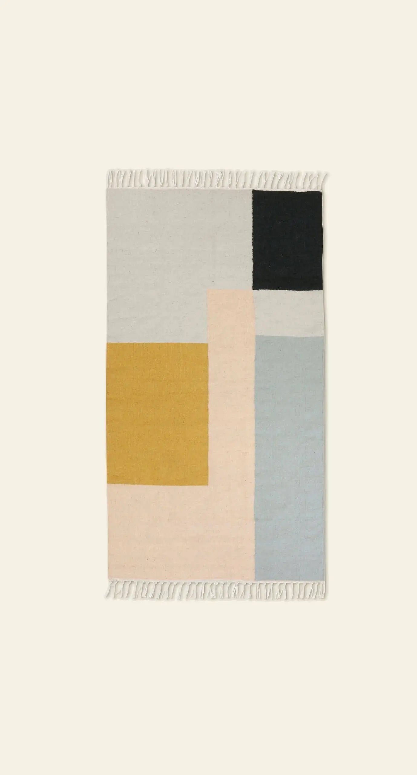 The ferm LIVING Kelim Rug by ferm LIVING features bold geometric color blocks in yellow, cream, light gray, black, and light blue on a light background, with short white fringe along the shorter edges for modern style.