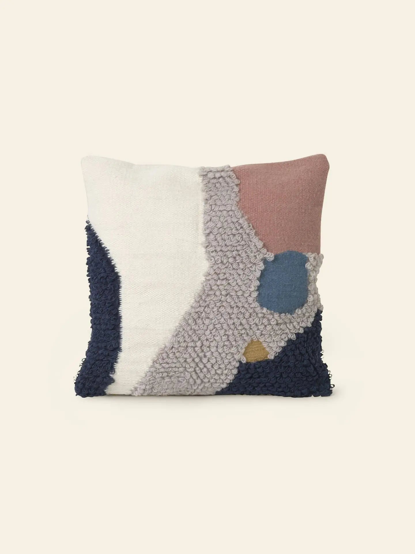 The ferm LIVING Loop Cushion by ferm LIVING features a textured abstract design in cream, navy blue, dusty pink, and tan New Zealand wool with raised and flat sections for contemporary style.