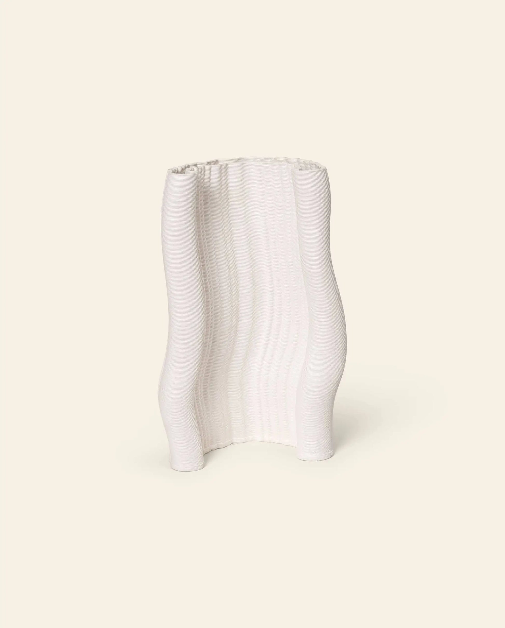 The ferm LIVING Moire Vase by ferm LIVING stands upright against a plain, cream-colored background, featuring wavy, uneven sides and a ribbed texture created through 3D printing.