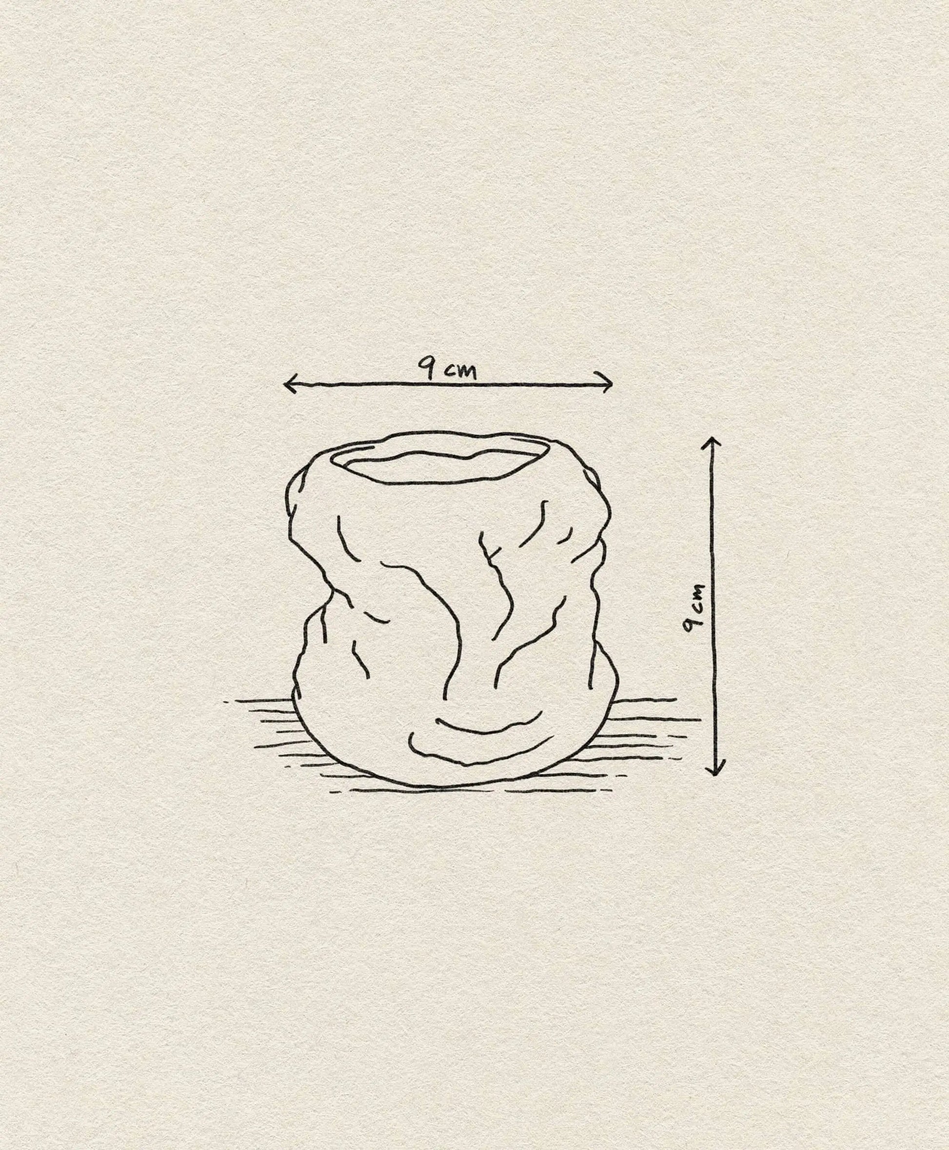 Line drawing of the ferm LIVING Tuck Scented Candle, a crumpled, cylindrical vessel inspired by stoneware glaze, 9 cm high and wide with dimension arrows, shown on a beige textured background. Brand: ferm LIVING.