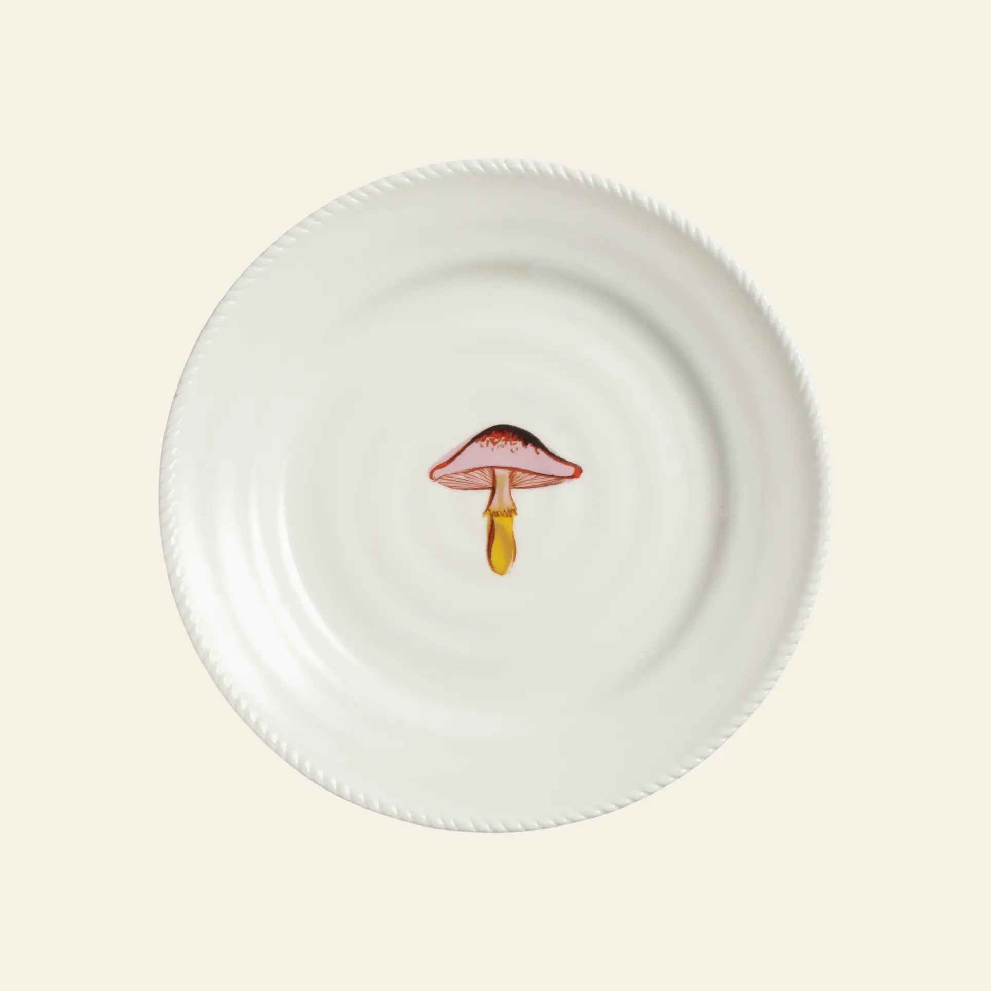 The &klevering Autumn Plate Small, Set of 4 by &klevering features white ceramic plates with a charming pink and yellow mushroom motif at the center, adding a touch of nature-inspired style to your tableware.