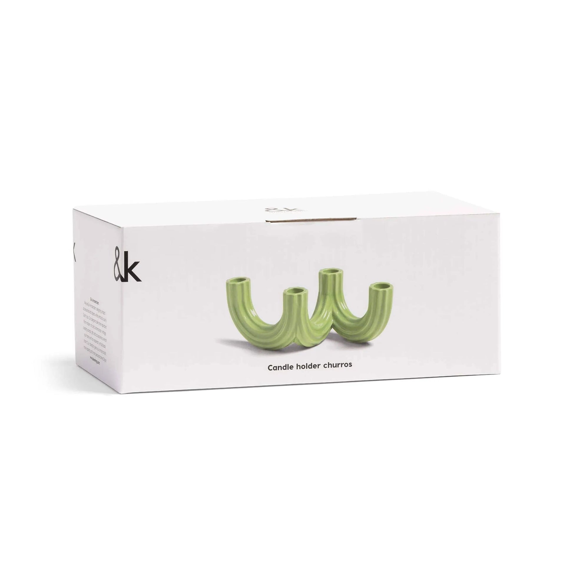 A white box branded “&klevering” holds the Churros Candle Holder Green—a unique, wavy candle holder with three openings, perfect for stylish home decor.