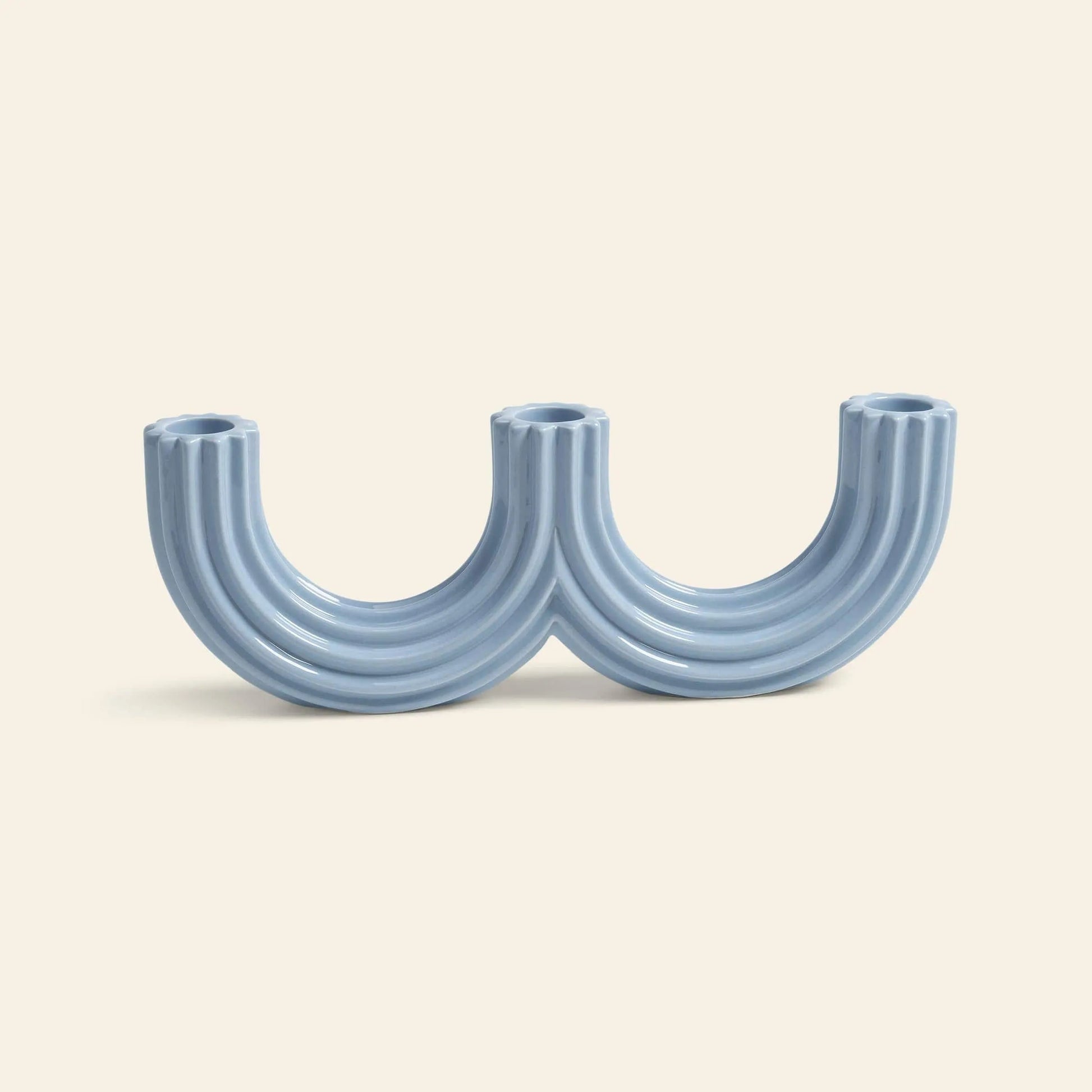 The &klevering Churros Candle Holder Light Blue by &klevering features modern, handcrafted ceramic in twin arches, forming a double U—an eye-catching decor piece for any home.