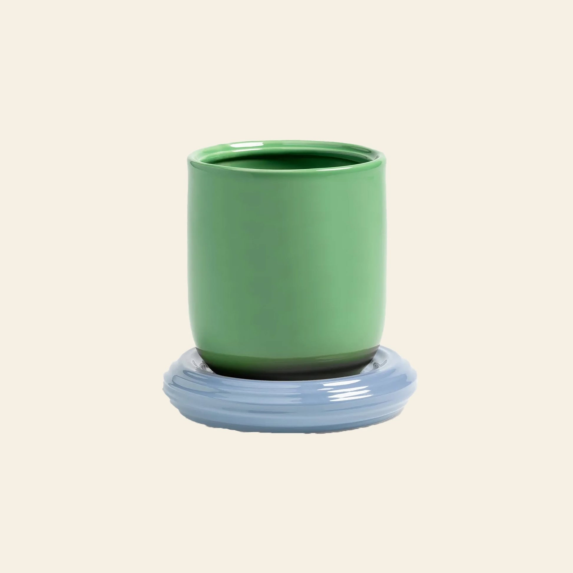 The &klevering Churros Planter by &klevering stands out against a plain beige background, its bright green ceramic finish adding a cheerful pop to the scene.