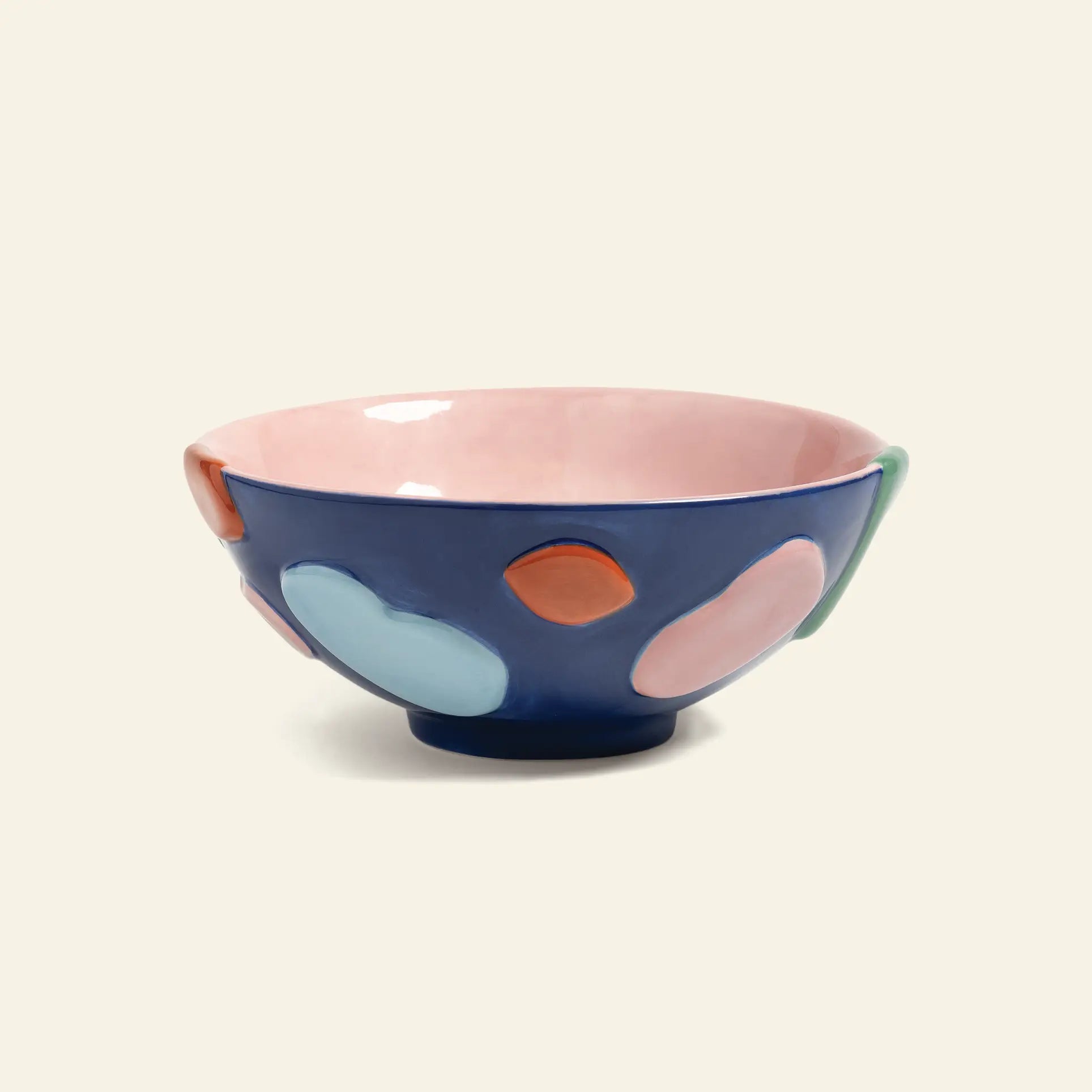 Enhance your table with the &klevering Crafty Bowl, Small by &klevering, showcasing a glossy pink interior and dark blue exterior decorated with vibrant abstract shapes in blue, orange, pink, and green.