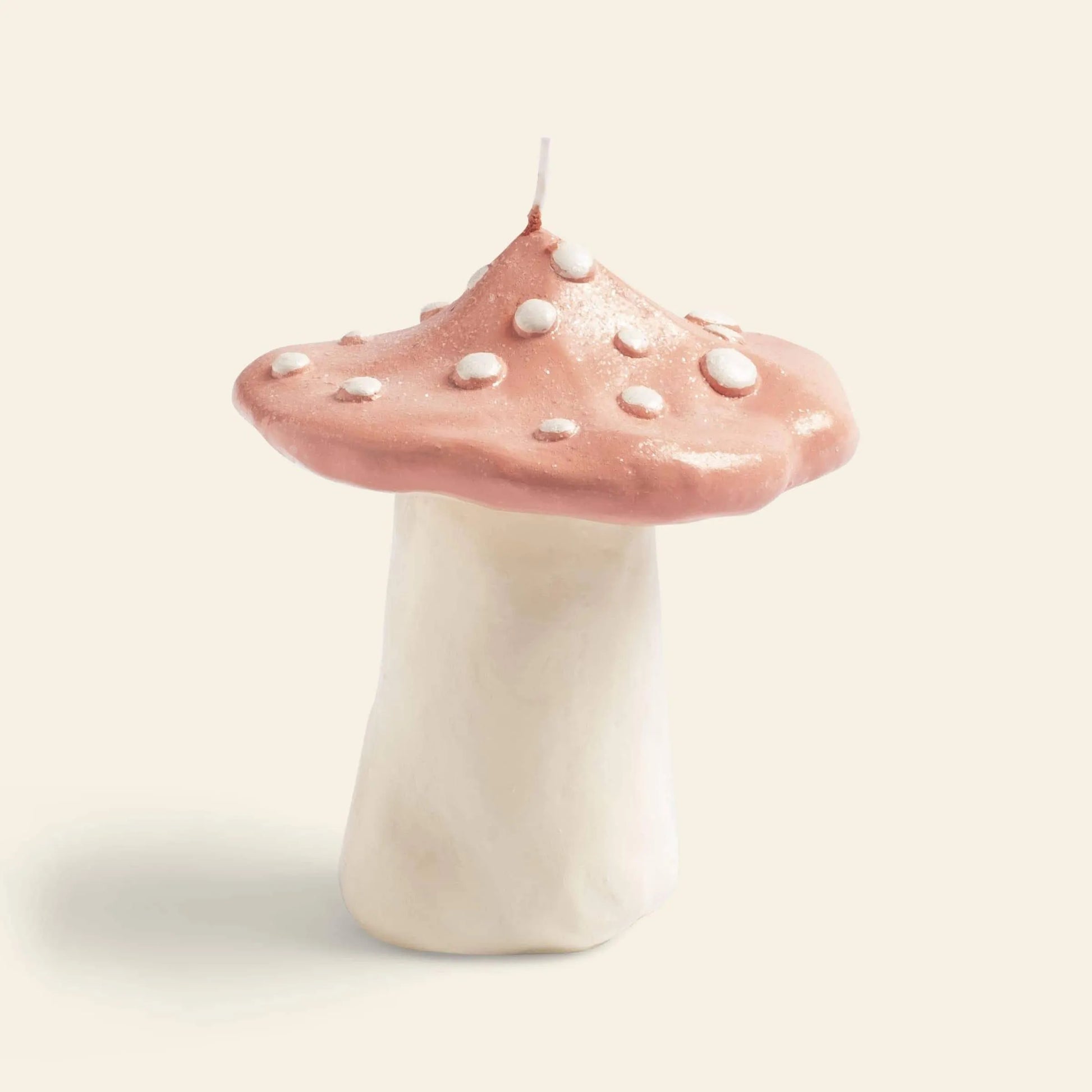 Illuminate your space with the &klevering Dots Mushroom Candle, featuring a whimsical design with a thick white stem and rounded pink cap dotted in white—perfect for adding enchanting ambiance to any plain light background.