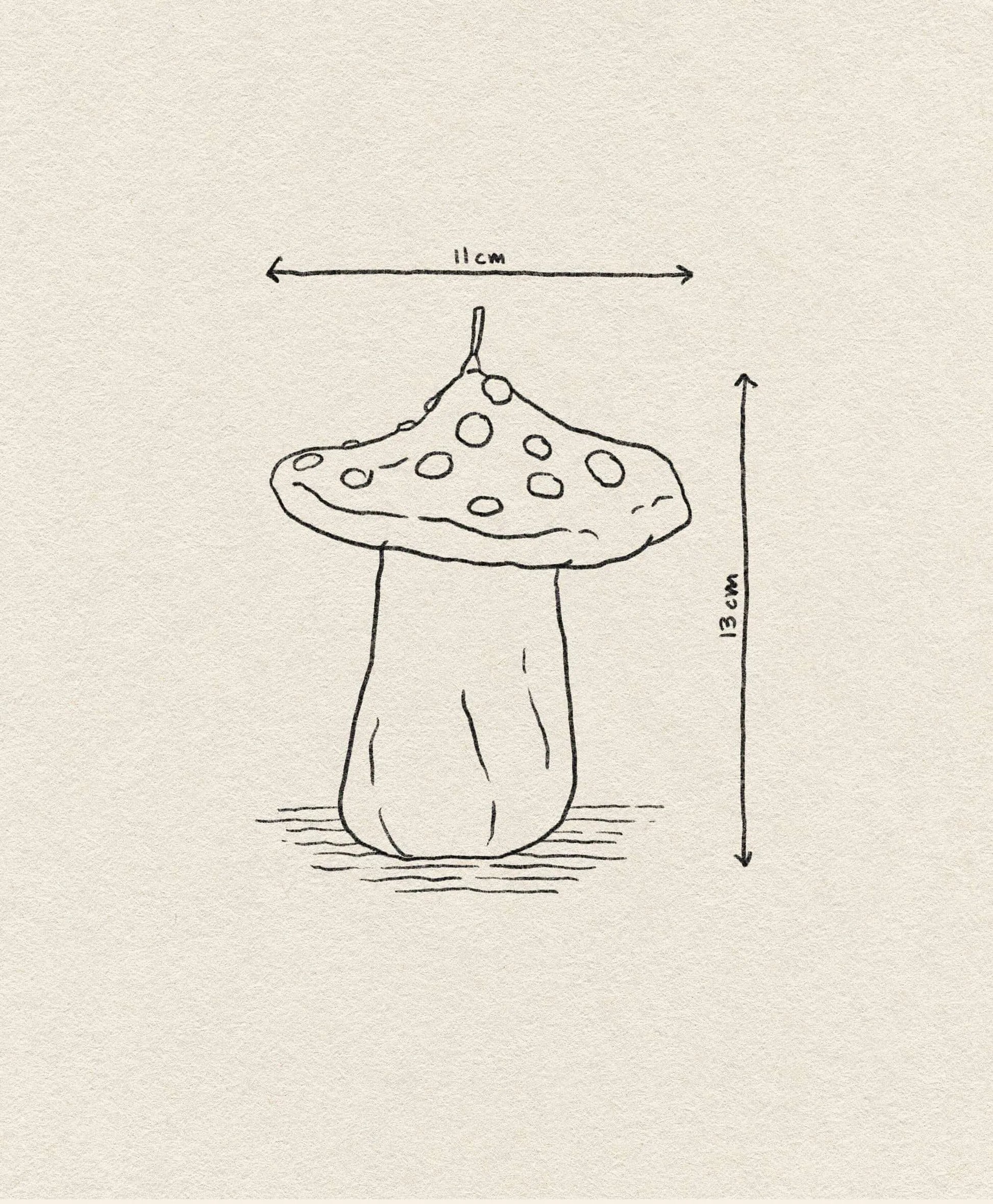 A simple line drawing of the &klevering Dots Mushroom Candle by &klevering, featuring a spotted cap and measuring 11 cm wide by 13 cm tall, on textured paper—ideal for adding an enchanting touch to any space.