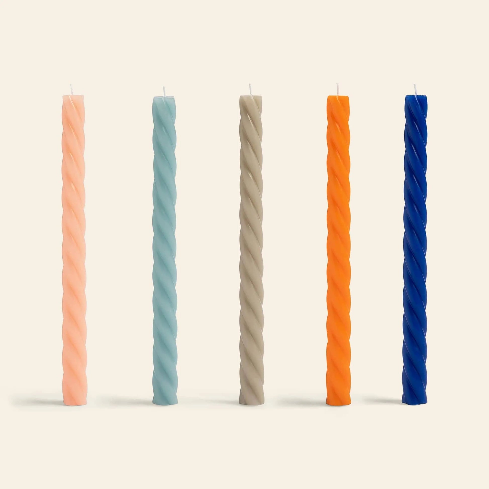 The &klevering Marshmallow Candle Set of 5 features tall, twisted handcrafted candles in pastel pink, light blue, beige, orange, and dark blue—perfect for adding a whimsical touch to any setting.