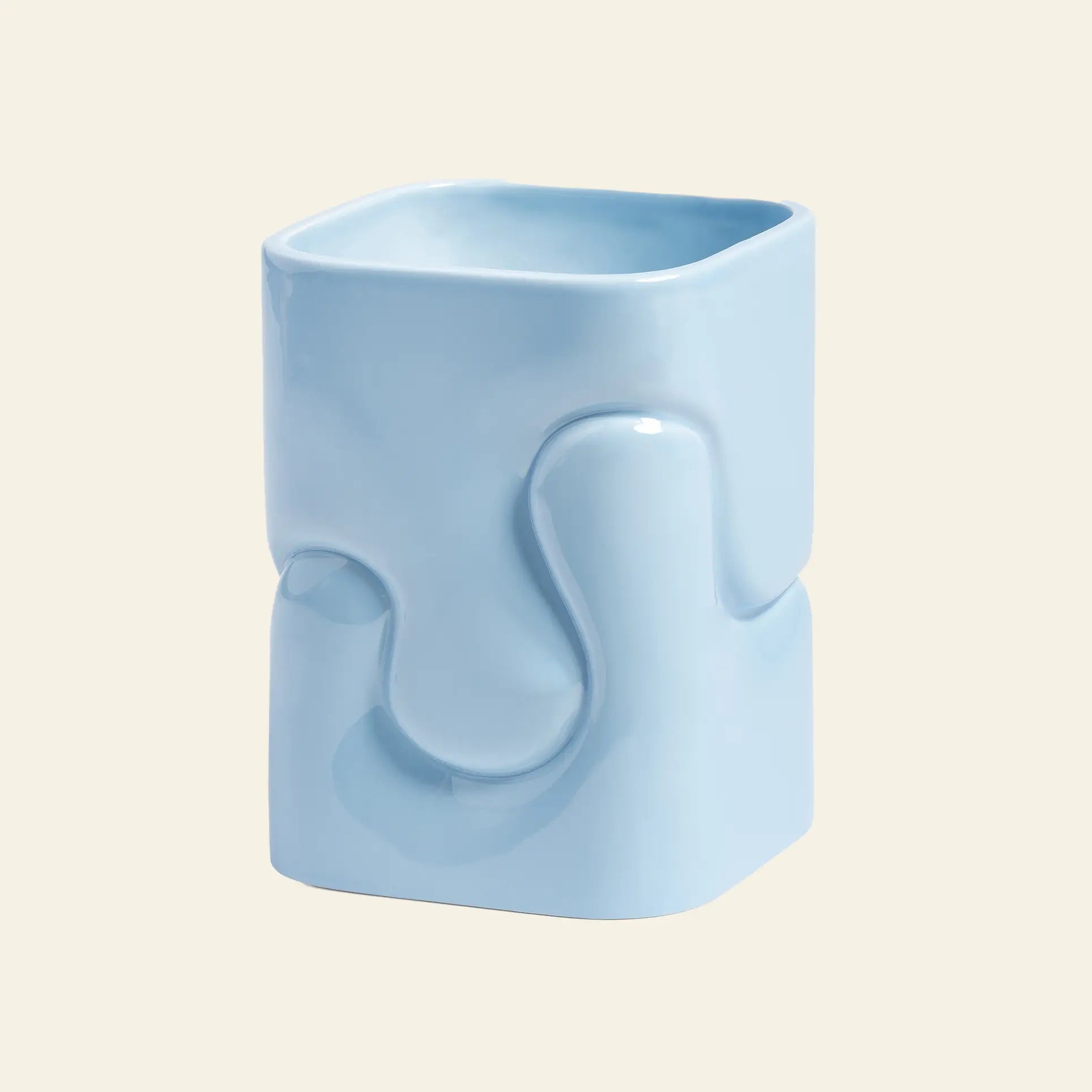The &klevering Puffy Vase by &klevering features a glossy light blue ceramic surface with a unique, abstract wavy and sculpted design, beautifully highlighted against a plain beige background.
