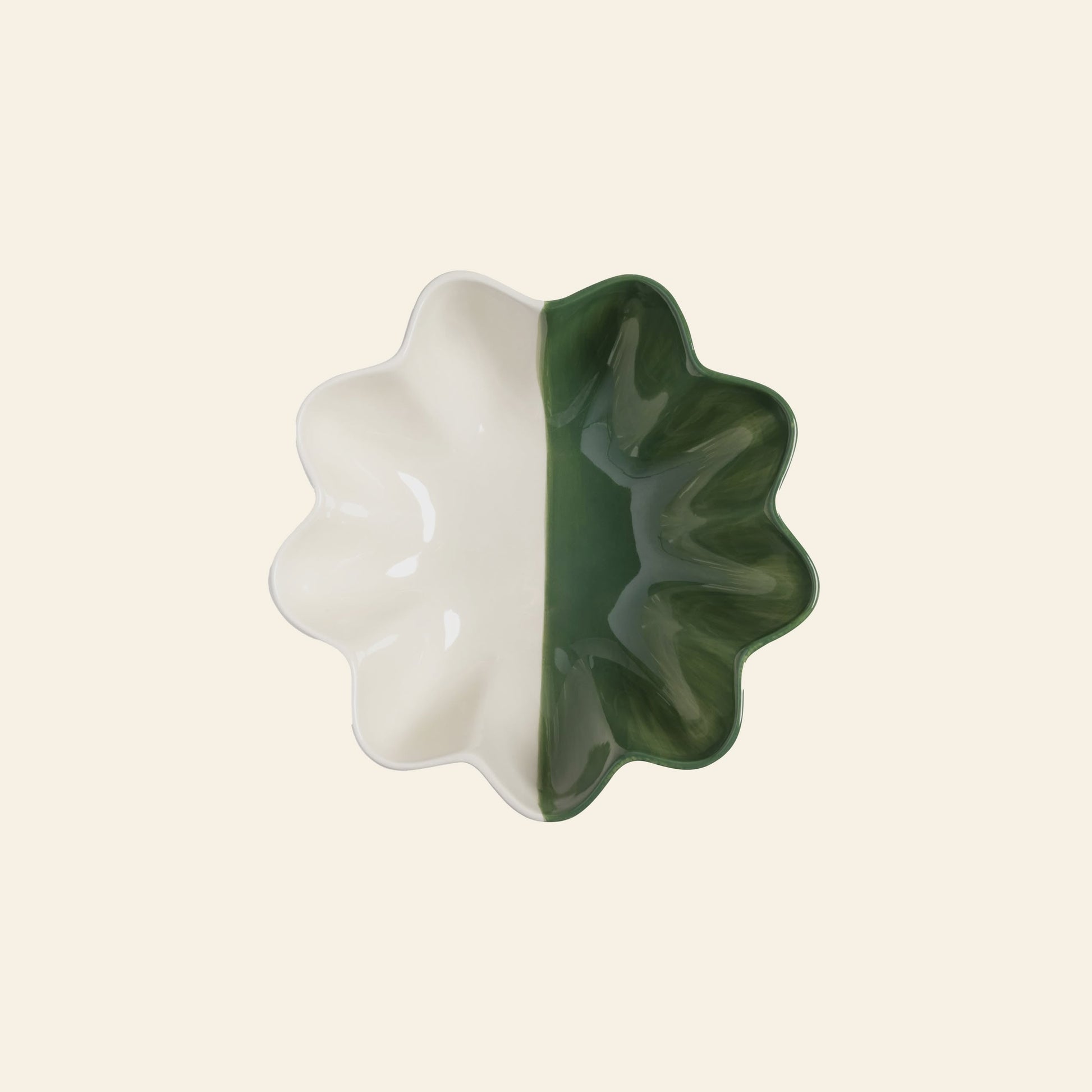 The &klevering Sun Bowl by &klevering features wavy edges and a half-cream, half-dark green design, shown from above on a light beige background—a striking modern accent for any space.