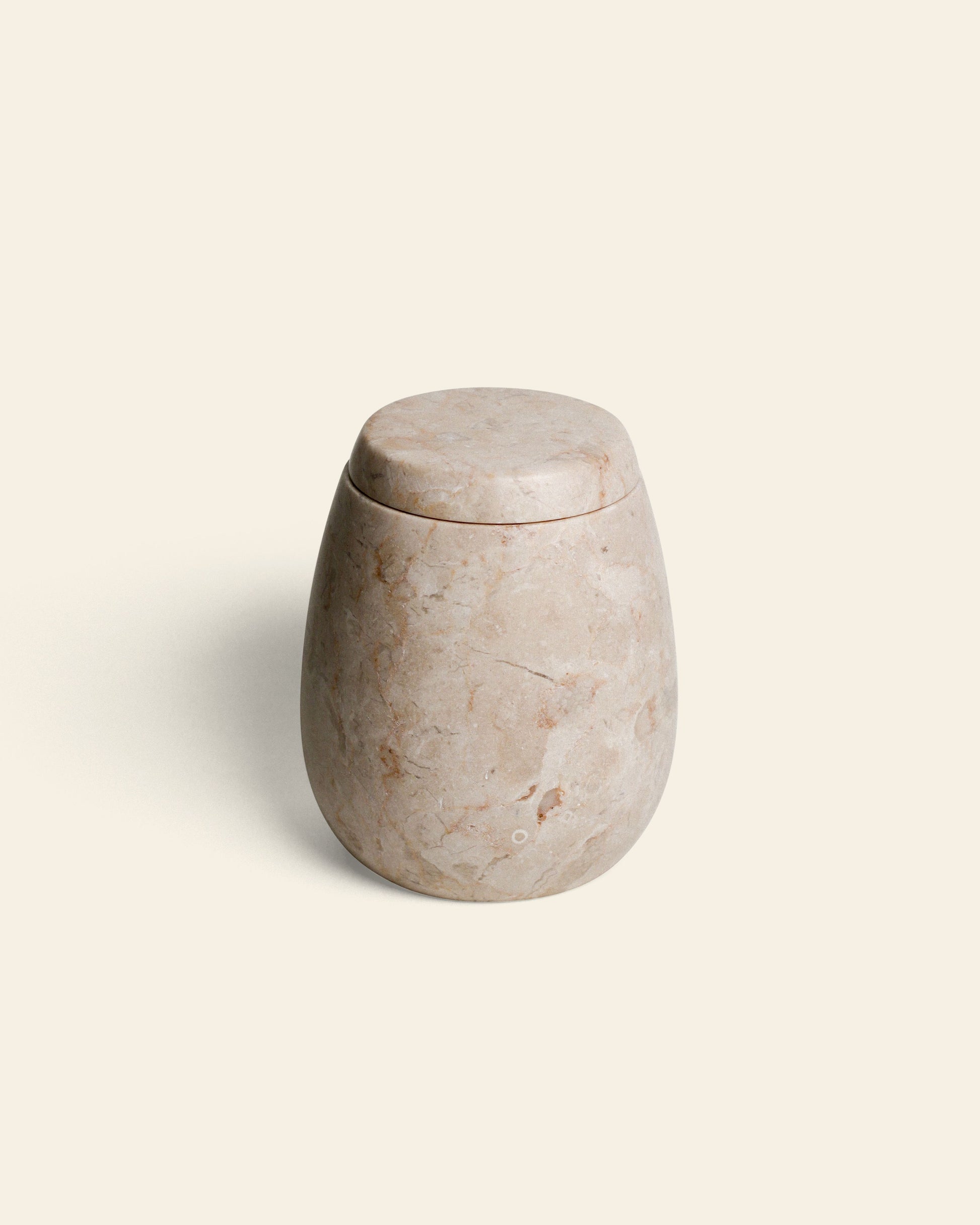 The stillgoods Ecru Jar features a smooth, rounded design with a matching lid, ideal for storing condiments or organizing essentials. Shown against a plain off-white background.
