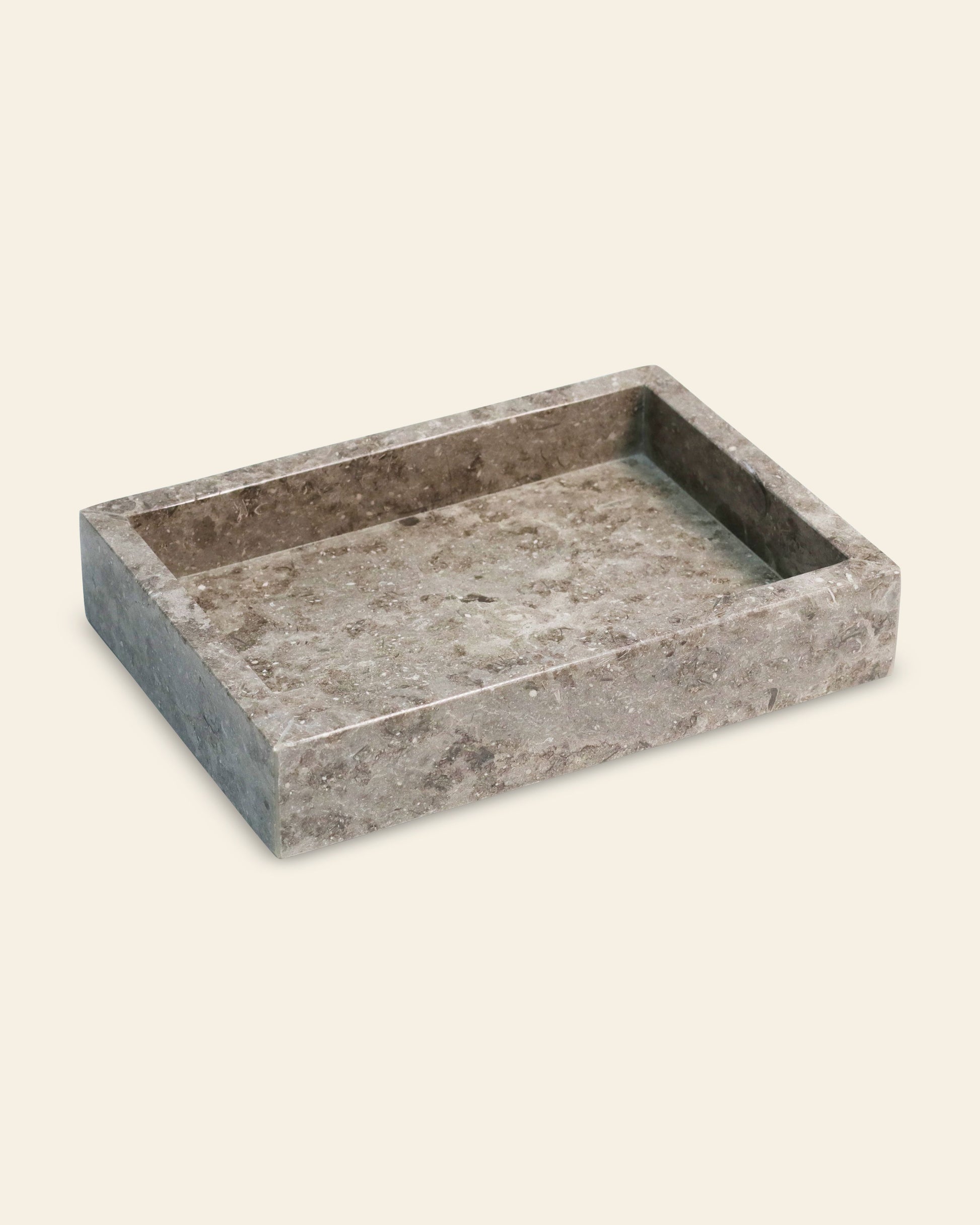 The stillgoods Mini Valor Tray is a rectangular, shallow gray marble tray with a low profile and raised edge—ideal for stylishly organizing essentials on any light surface.