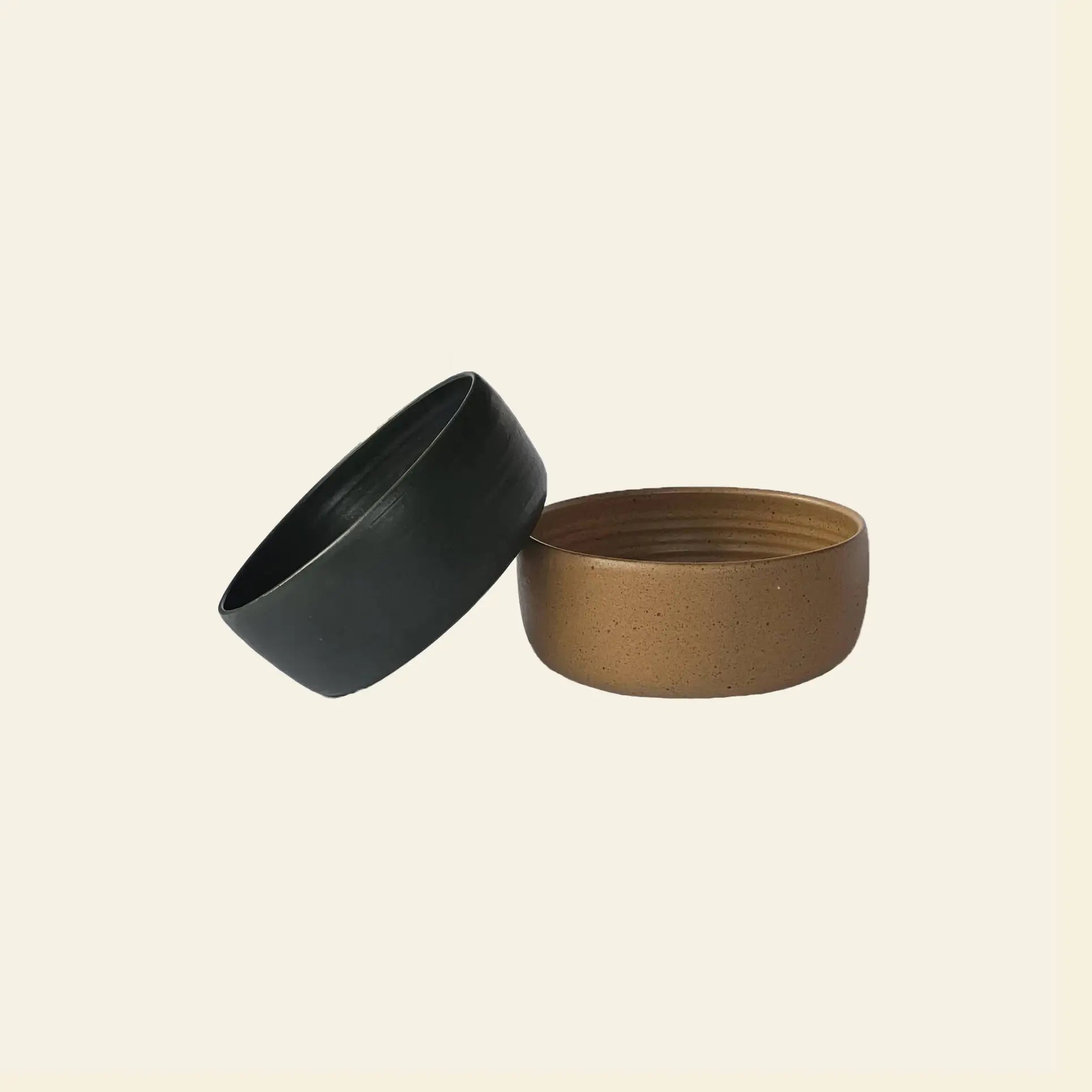 The ves Boro Ramen Bowl Set of 2 by ves features handmade ceramic bowls—one matte black, one speckled brown—shown side by side on a plain background. Both have a simple, modern design ideal for serving ramen.
