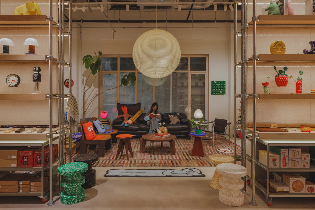 The living-room corner at Stacked Store New Bahru, with a leather sofa, an Akari paper lamp and a coffee table