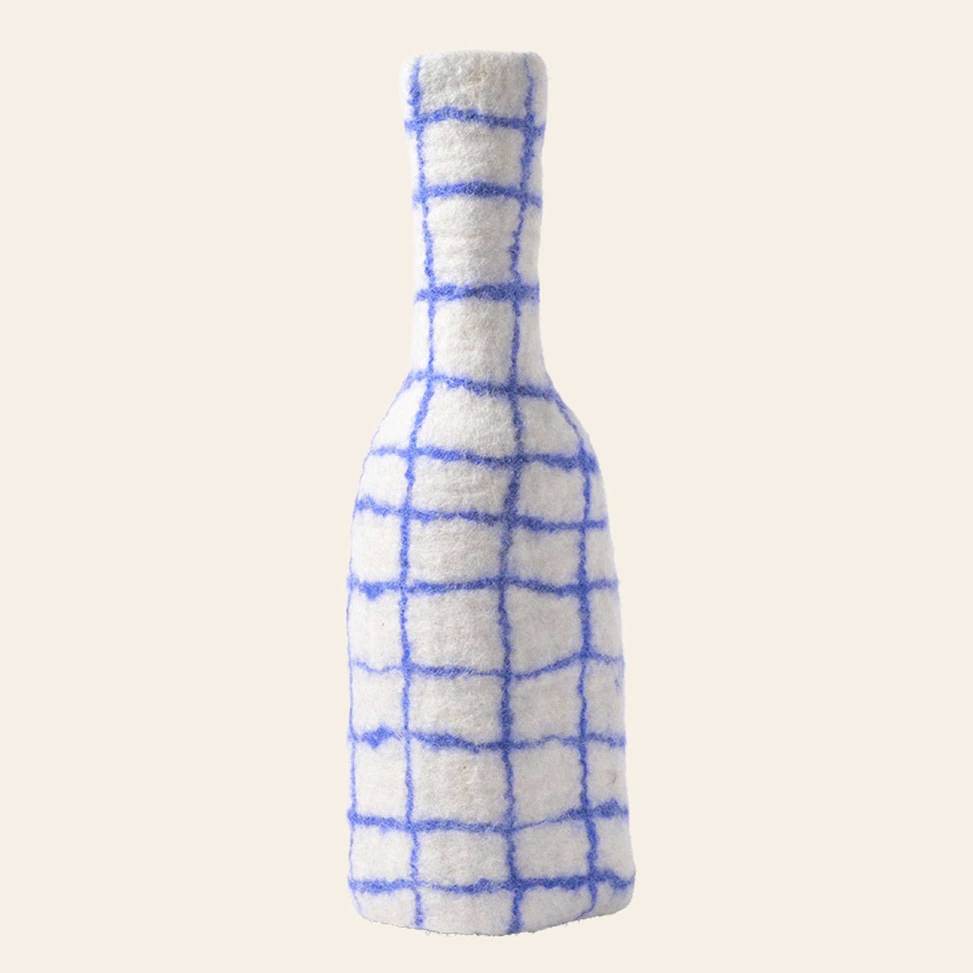 The Aveva Design Bottle/Vase Cover - Blue Checked by Aveva Design is a textured, fuzzy white wool cover with a blue checked pattern, shown standing upright on a plain light background.