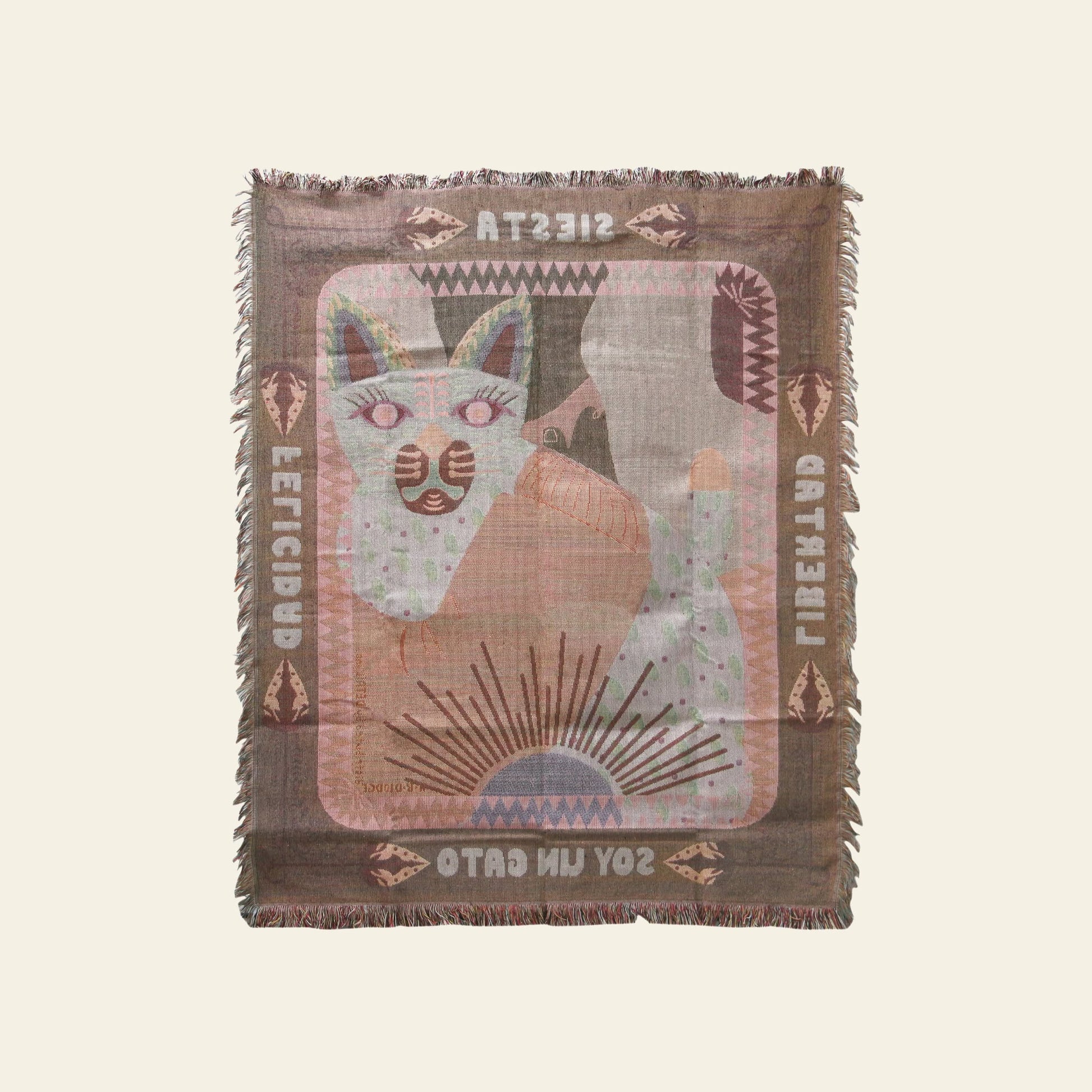 The DETAIL Cat Oax Throwket by DETAIL features a stylized feline design with geometric and folk art patterns, fringed edges, and text reading SIESTA, FELICIDAD, LIBERTAD, and SOY UN GATO around the border.