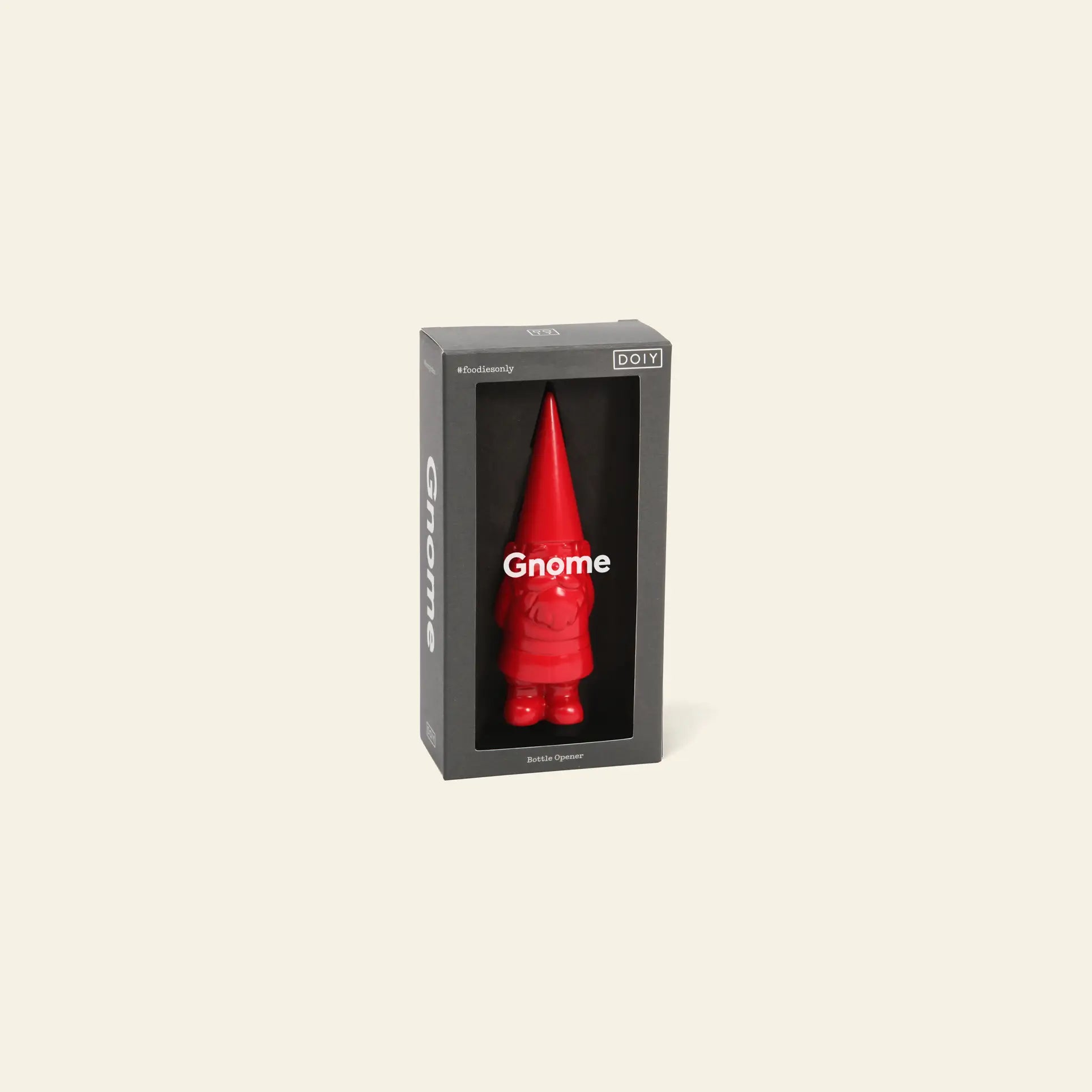 The DOIY Gnome Bottle Opener, by DOIY, is a red gnome-shaped metal opener in a black box with a clear front and Gnome printed on it. The playful packaging is shown against a neutral light background.