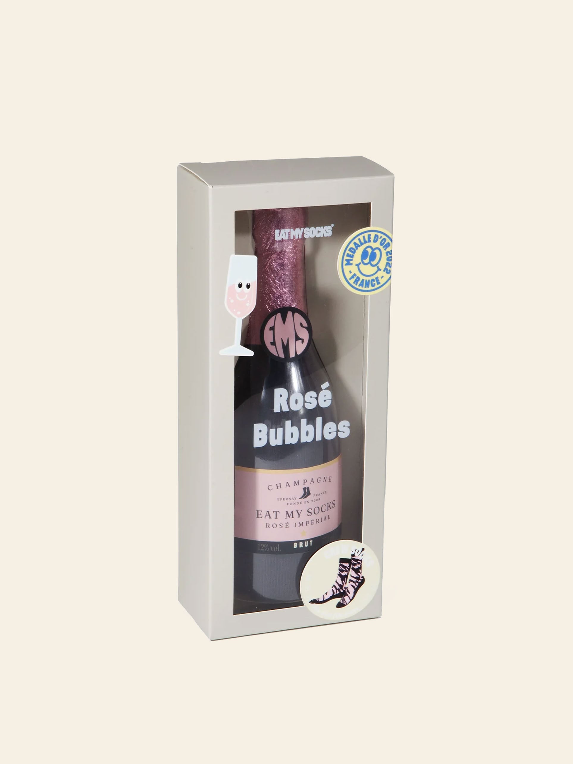 Presented in a gift box designed to resemble a bottle of rosé champagne, Eat My Socks Rosé Bubbles Socks by Eat My Socks feature an abstract pink unisex sock pattern. The playful packaging, decorated with illustrations of a wine glass and a sock, makes them a stylish and fun treat for any occasion.