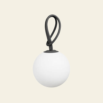 The Fatboy Bolleke by Fatboy is a round, white, matte globe-shaped portable light with a black flexible loop handle, set against a light beige background—ideal as an indoor-outdoor lighting solution or stylish hanging lamp.