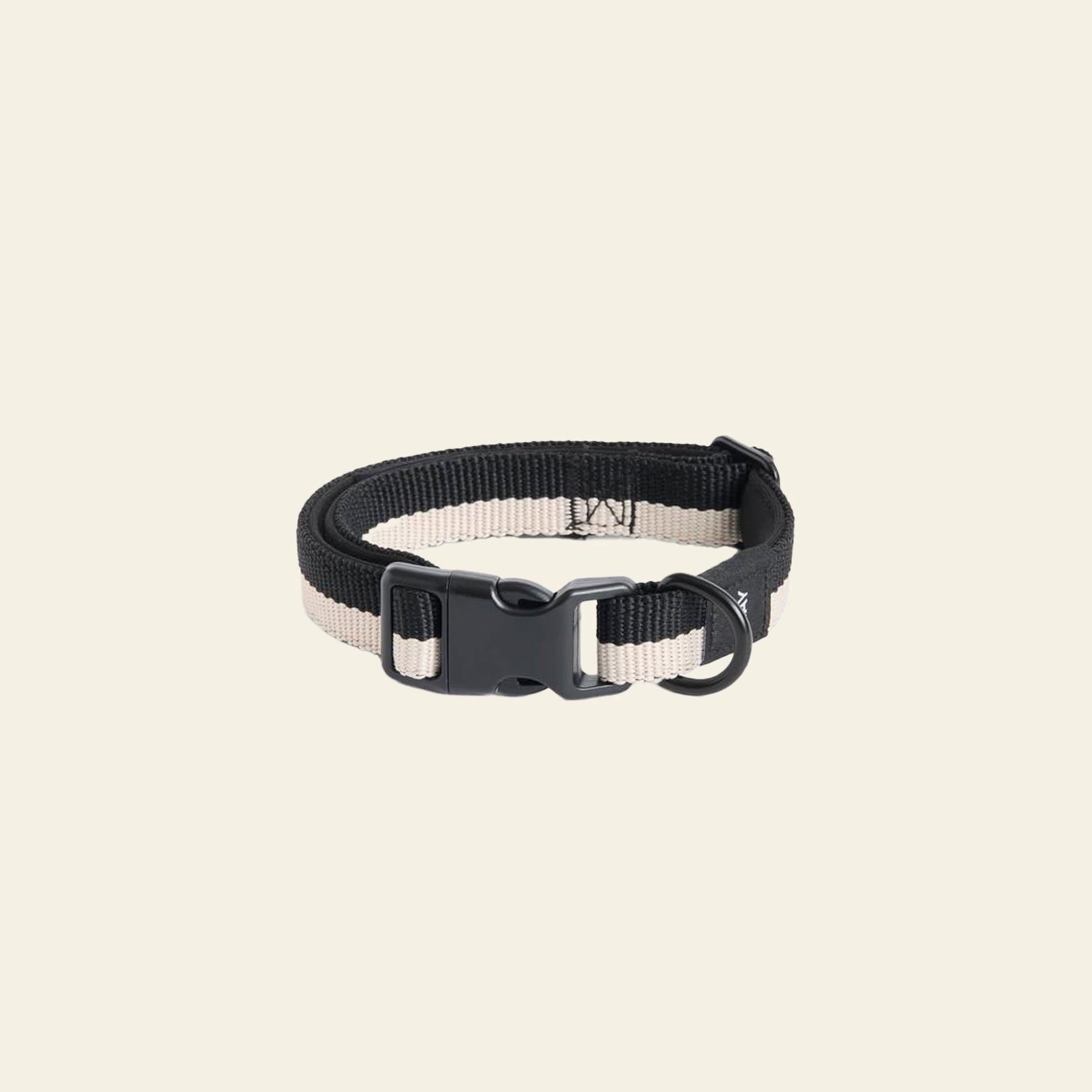 The HAY Dogs Collar Flat S/M by HAY, in black and beige recycled polyester, features an adjustable buckle, plastic clasp, and metal D-ring, shown on a plain light background.