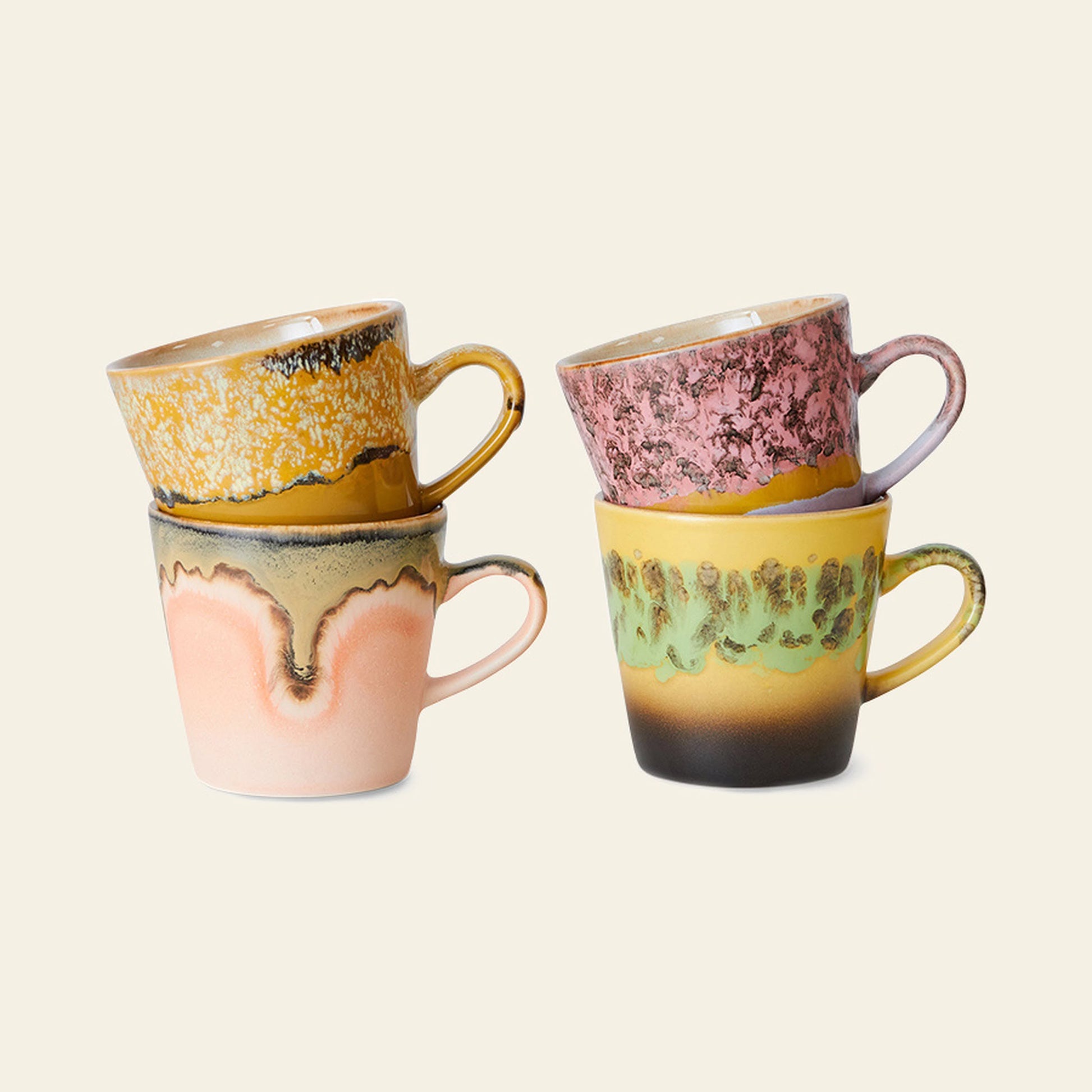 The HKliving 70s Ceramics: Americano Mugs, Set of 4 features uniquely glazed ceramic mugs in yellow, pink, green, and brown. Each mug’s colorful textured finish channels retro charm, shown stacked against a light beige background.