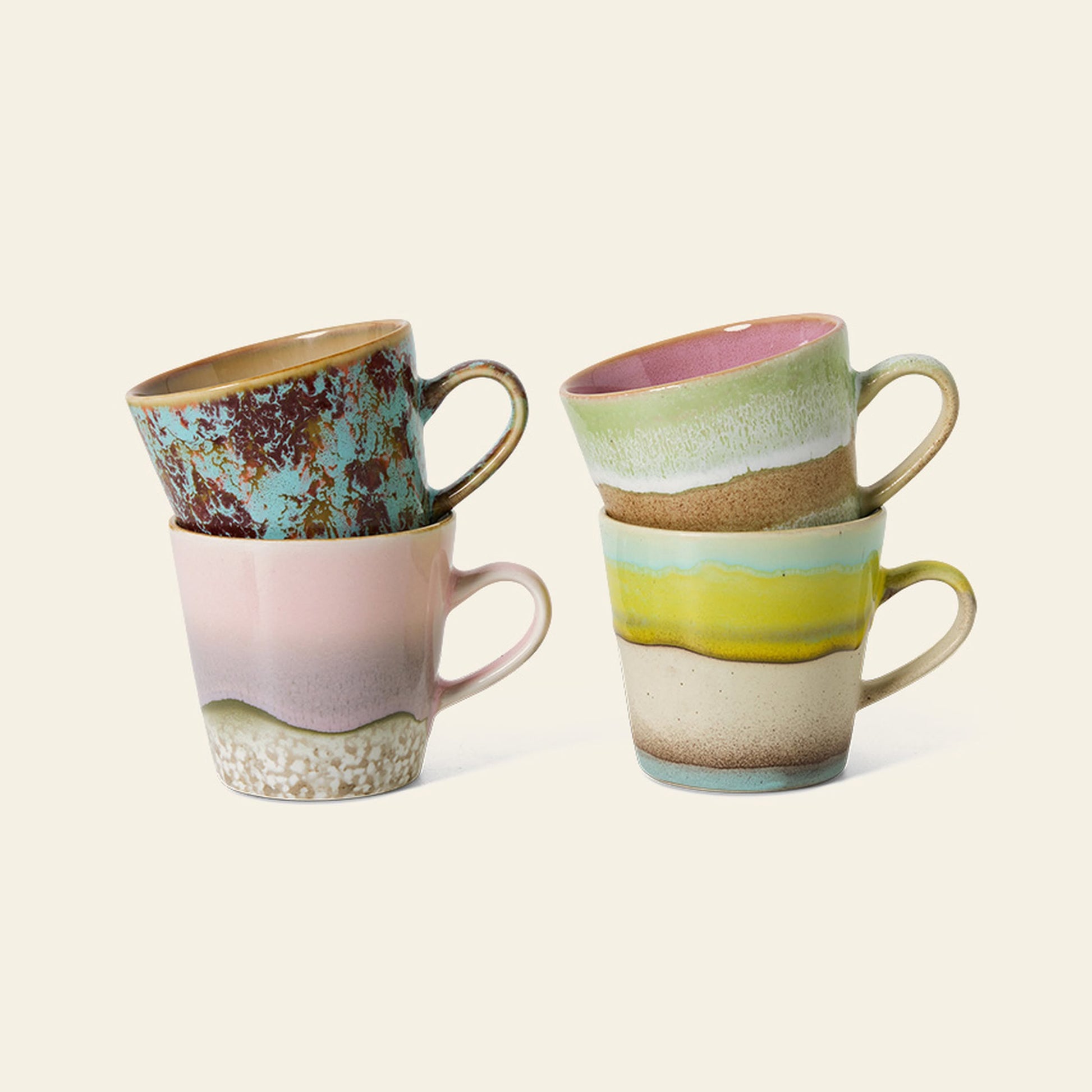 Four HKliving 70s Ceramics Americano Mugs, each with distinct pastel and earthy patterns, are stacked in pairs against a plain light background. Set of 4 by HKliving.