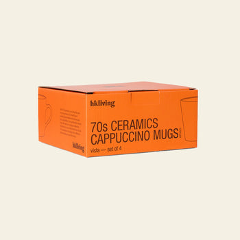 A rectangular orange box labeled HKliving 70s Ceramics: Cappuccino Mugs, Set of 4, with minimal cup illustrations on a plain background—ideal for retro mug fans.