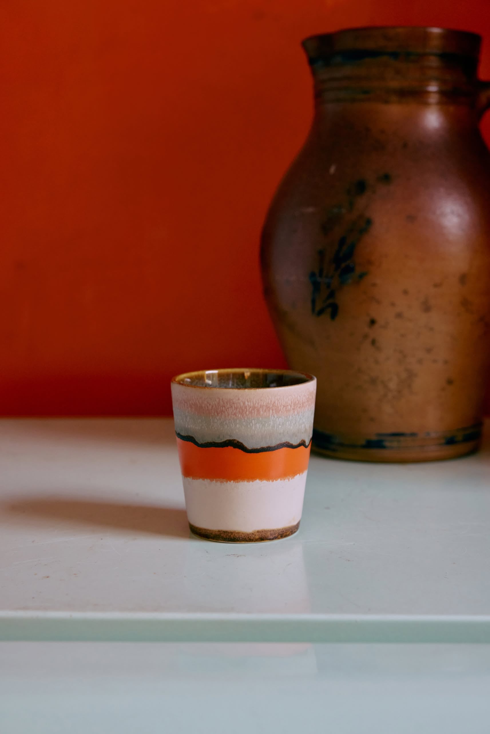 The HKliving 70s Ceramics: Coffee Mugs (Set of 6) by HKliving features orange, white, and black stripes—adding retro charm to any space with their classic 70s design.