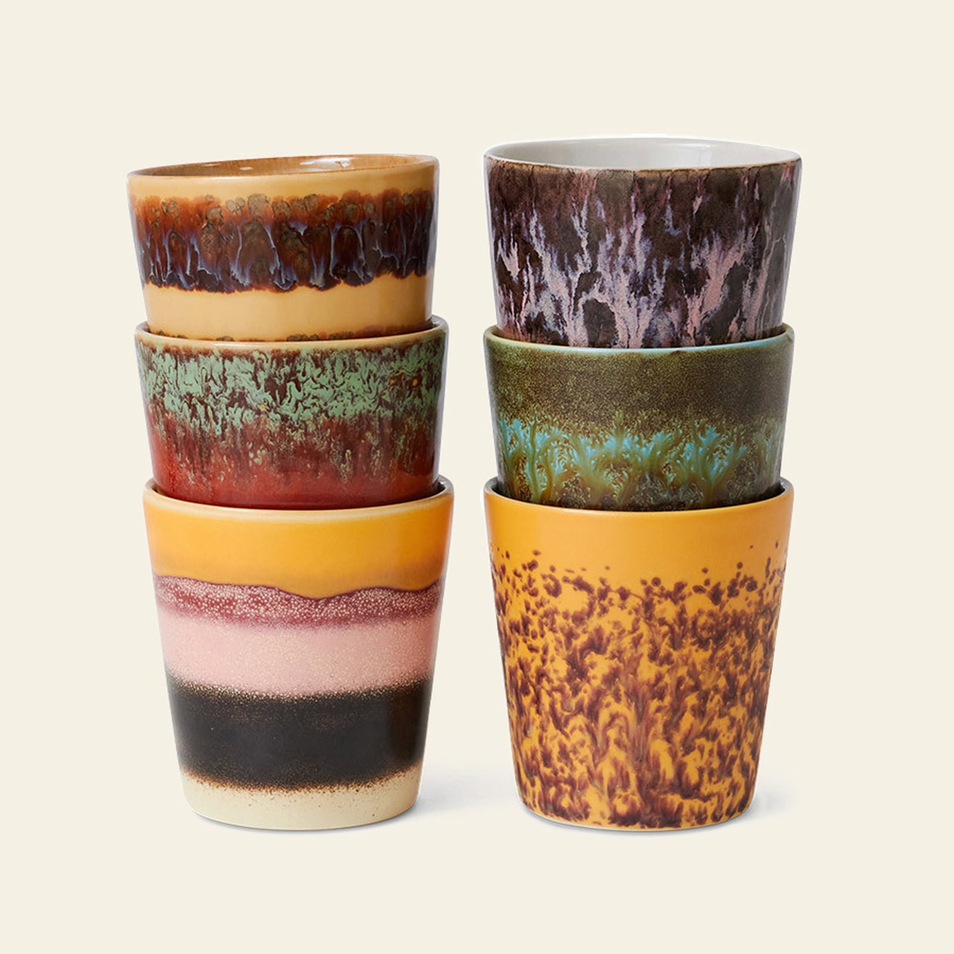 The HKliving 70s Ceramics: Coffee Mugs, Set of 6 features unique patterns and earthy tones—red, brown, green, yellow, and purple—on textured ceramic mugs stacked in two columns of three, inspired by classic 1970s designs.