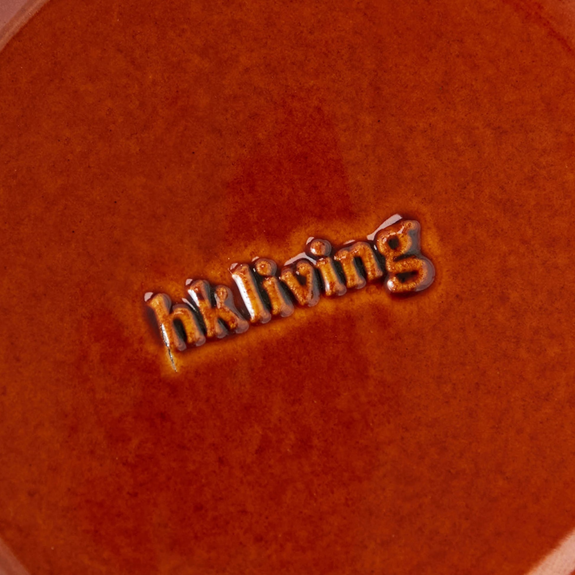 A close-up of the HKliving 70s Ceramics Dessert Bowls surface, featuring the glazed, embossed HKliving logo at the center and capturing the retro charm of 1970s-inspired tableware.
