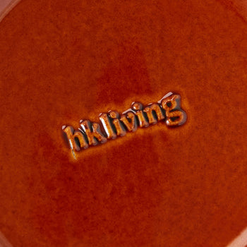 A close-up of the HKliving 70s Ceramics Dessert Bowls surface, featuring the glazed, embossed HKliving logo at the center and capturing the retro charm of 1970s-inspired tableware.