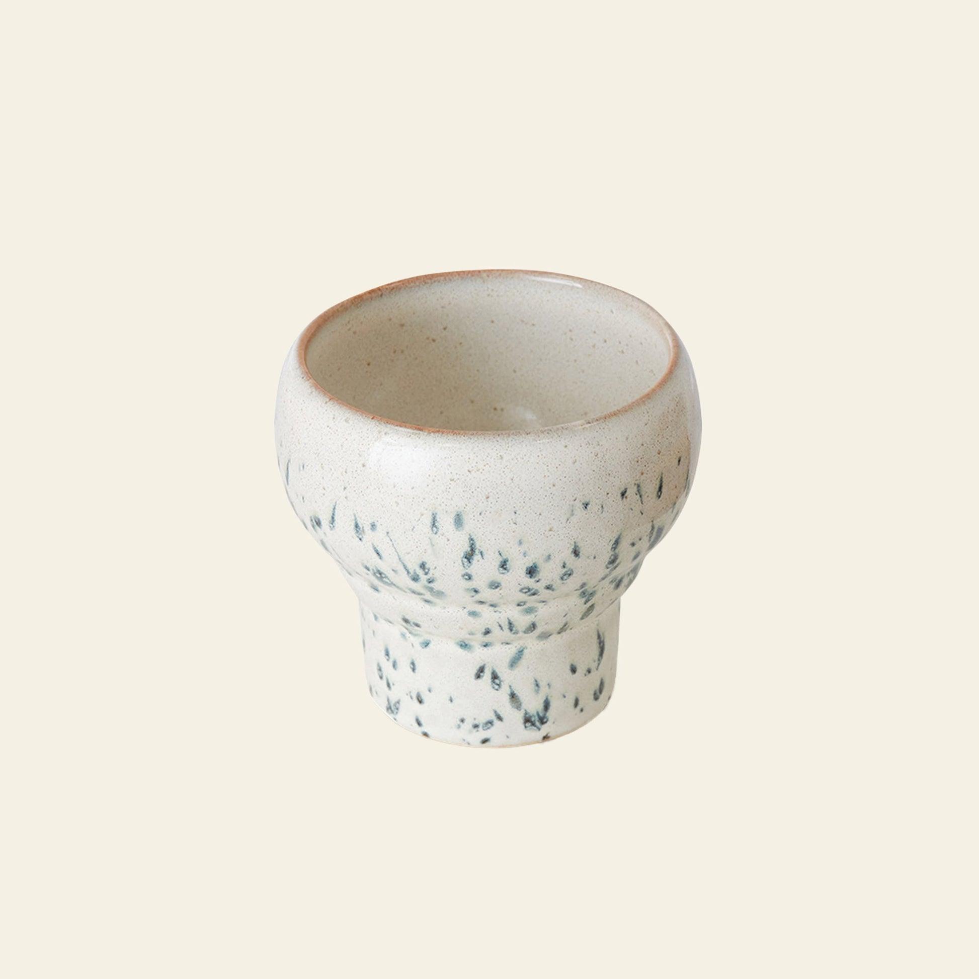 The HKLIVING 70s Ceramics: Lungo Mugs, Set of 2, features small, round ceramic cups with wide rims and cream glaze with green speckles—perfect for coffee lovers and a stylish addition to any modern kitchen.