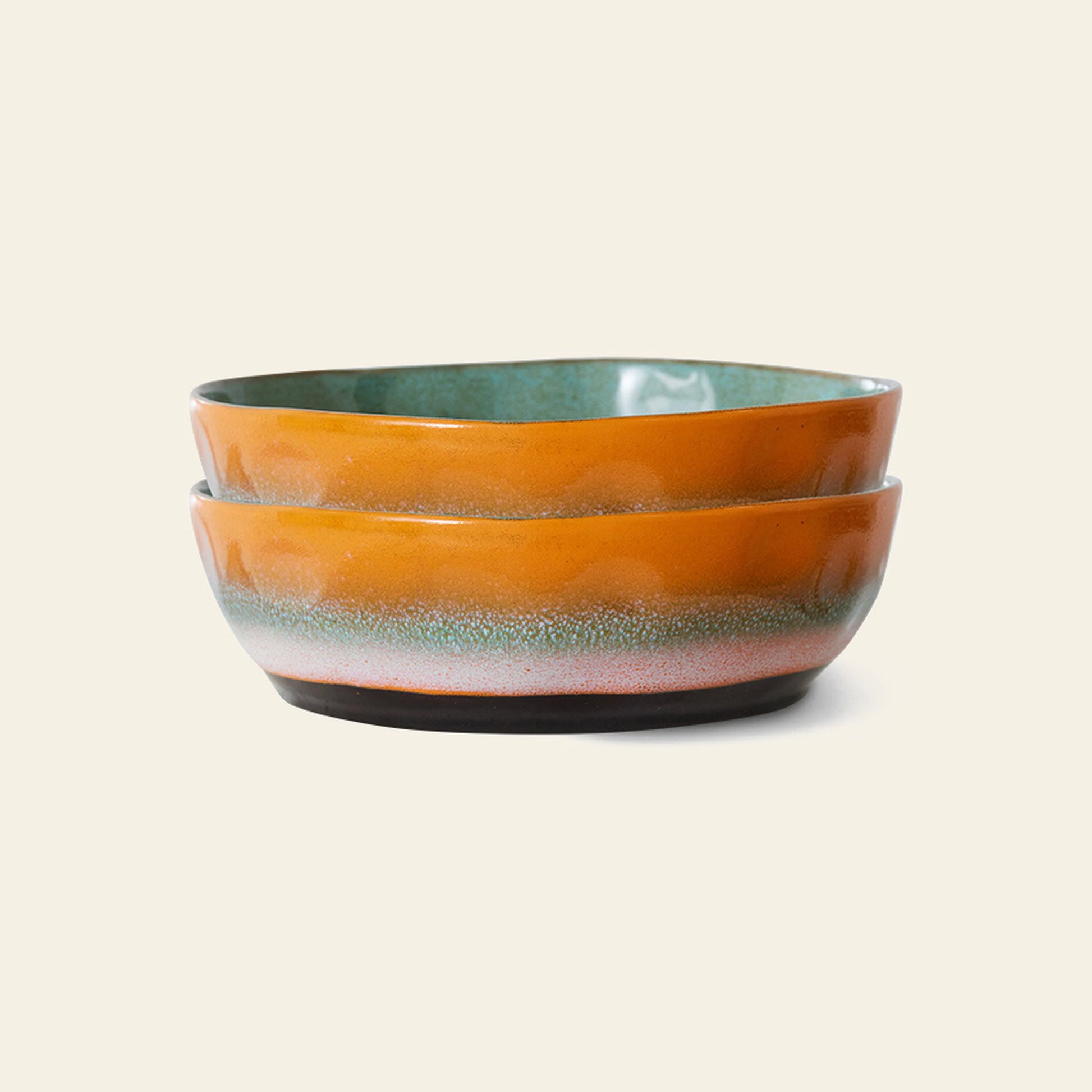 The HKliving 70s Ceramics: Pasta Bowls, Set of 2, feature a glossy orange exterior with a greenish-blue gradient at the base, reflecting retro style, shown stacked on a plain light background.