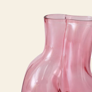 A close-up of the HKLIVING Gleam Glass Vase—a pink, translucent vase with a wavy, asymmetrical design by HKLIVING—displayed against an off-white background; an elegant accent for modern interiors.
