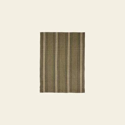 The HKLIVING Vida Striped Tea Towel in sand and cream features vertical black and beige stripes, echoing classic linen and cotton tea towel designs, shown against a plain light beige background.