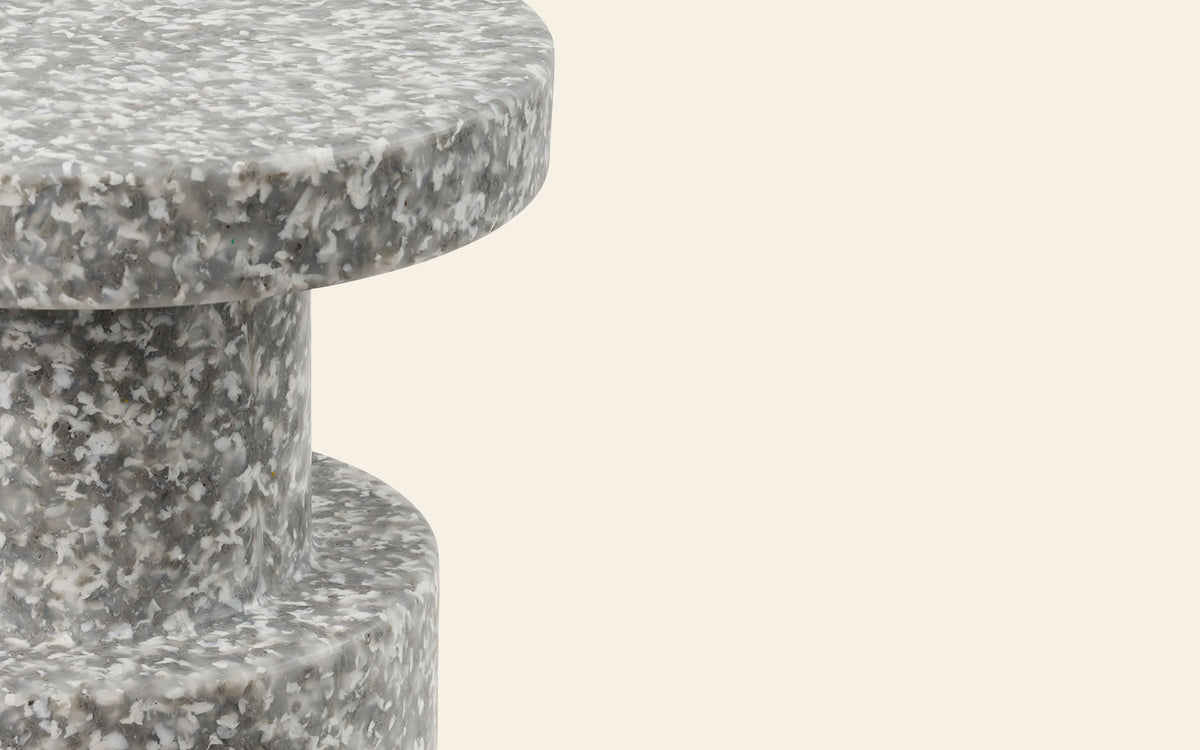 Close-up of a sculptural Normann Copenhagen Bit Stool with a gray and white speckled finish.