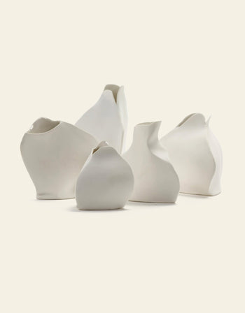The Serax Perfect Imperfection Flower Vase N°5 in white by Serax is displayed on a light beige background, featuring an irregular, handcrafted shape and a smooth porcelain surface for a unique, organic look.