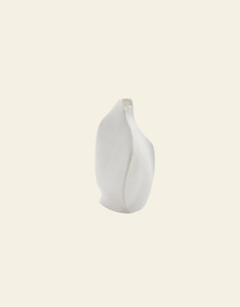 The Serax Perfect Imperfection Flower Vase S N°1 in white is a small, modern porcelain vase with an abstract, organic shape, designed by Roos van de Velde. It is shown against a plain off-white background.