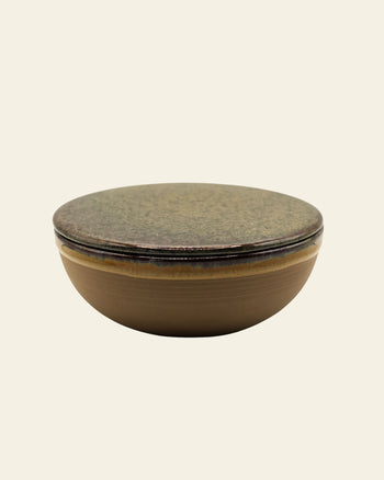 The Serax Surface Bowl & Lid in Indi Grey by Serax is a round, shallow handcrafted bowl with a matching flat lid, displayed against a plain light background.