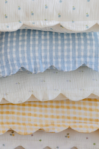 The Soft Spot Soft Petal Cushion Covers, Set of 2, by Soft Spot, feature scalloped edges and come in blue or yellow checks and blue-green floral prints on white, made from organic cotton.