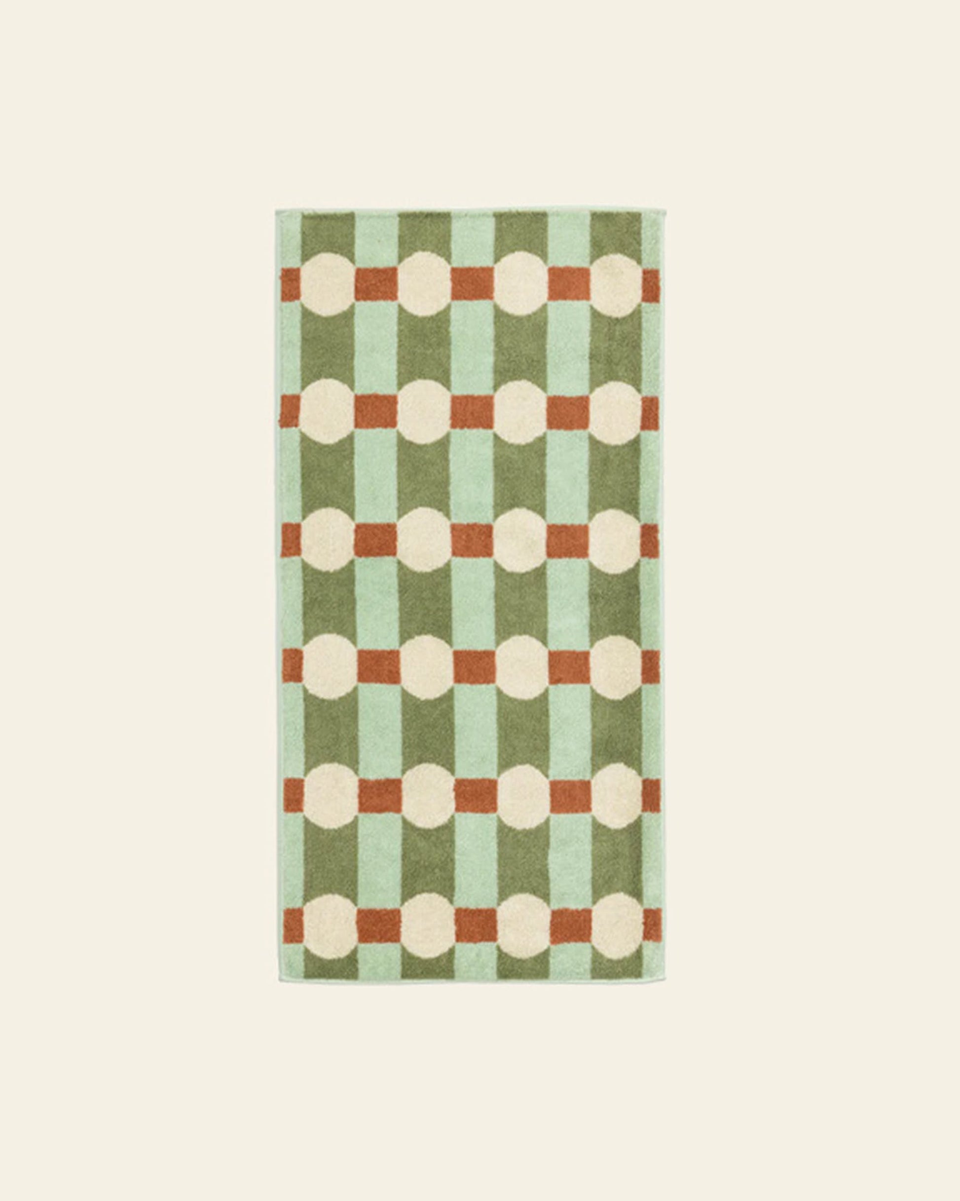 The WARMGREY TAIL Dot Check Face Towel features a checkered pattern in light and dark green with brown lines and cream circles, crafted from quality cotton terry fabric for lasting softness and durability.