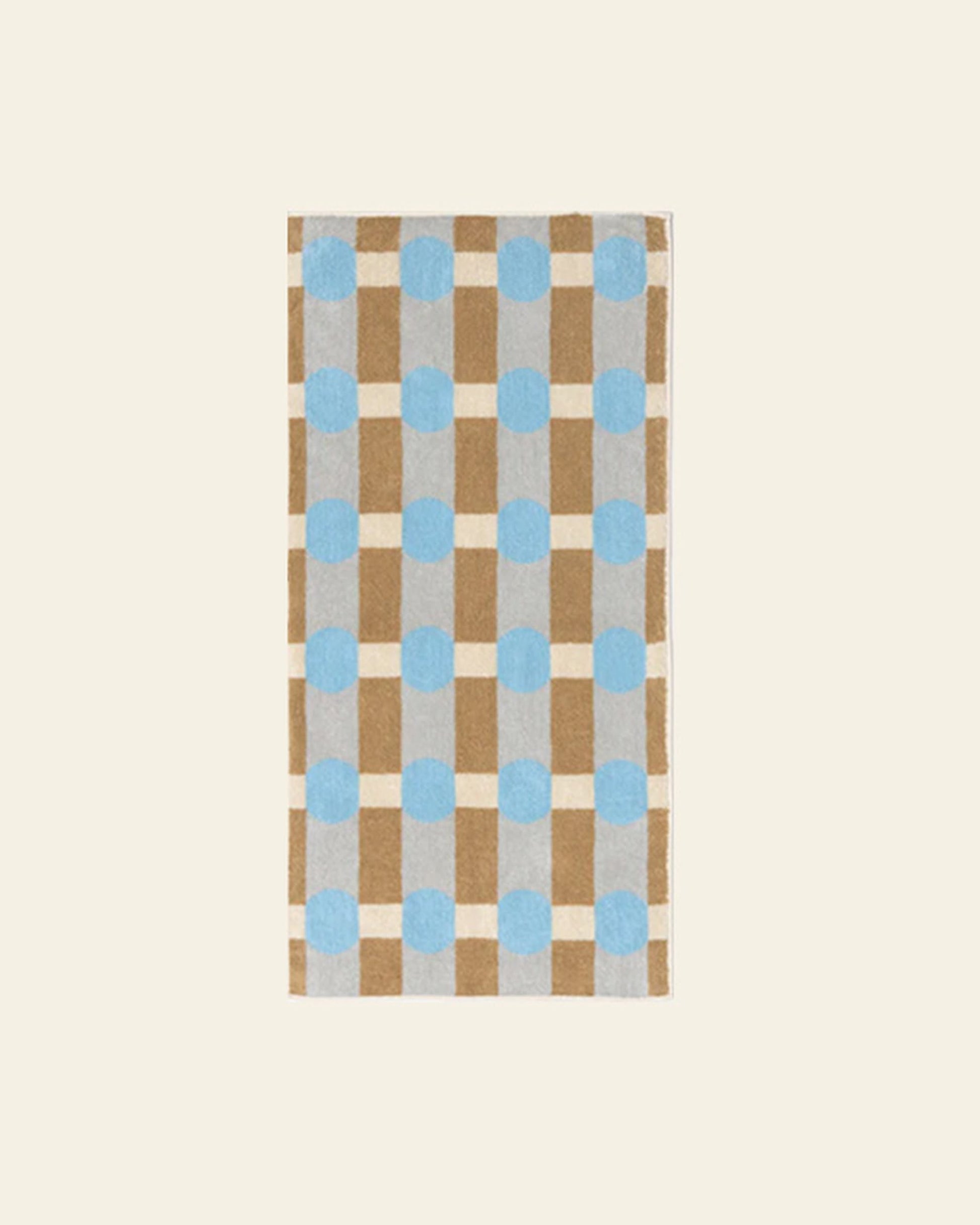 The WARMGREY TAIL Dot Check Face Towel is a rectangular cotton terry towel featuring a checkered pattern in light brown and cream with light blue dots on a plain beige background.