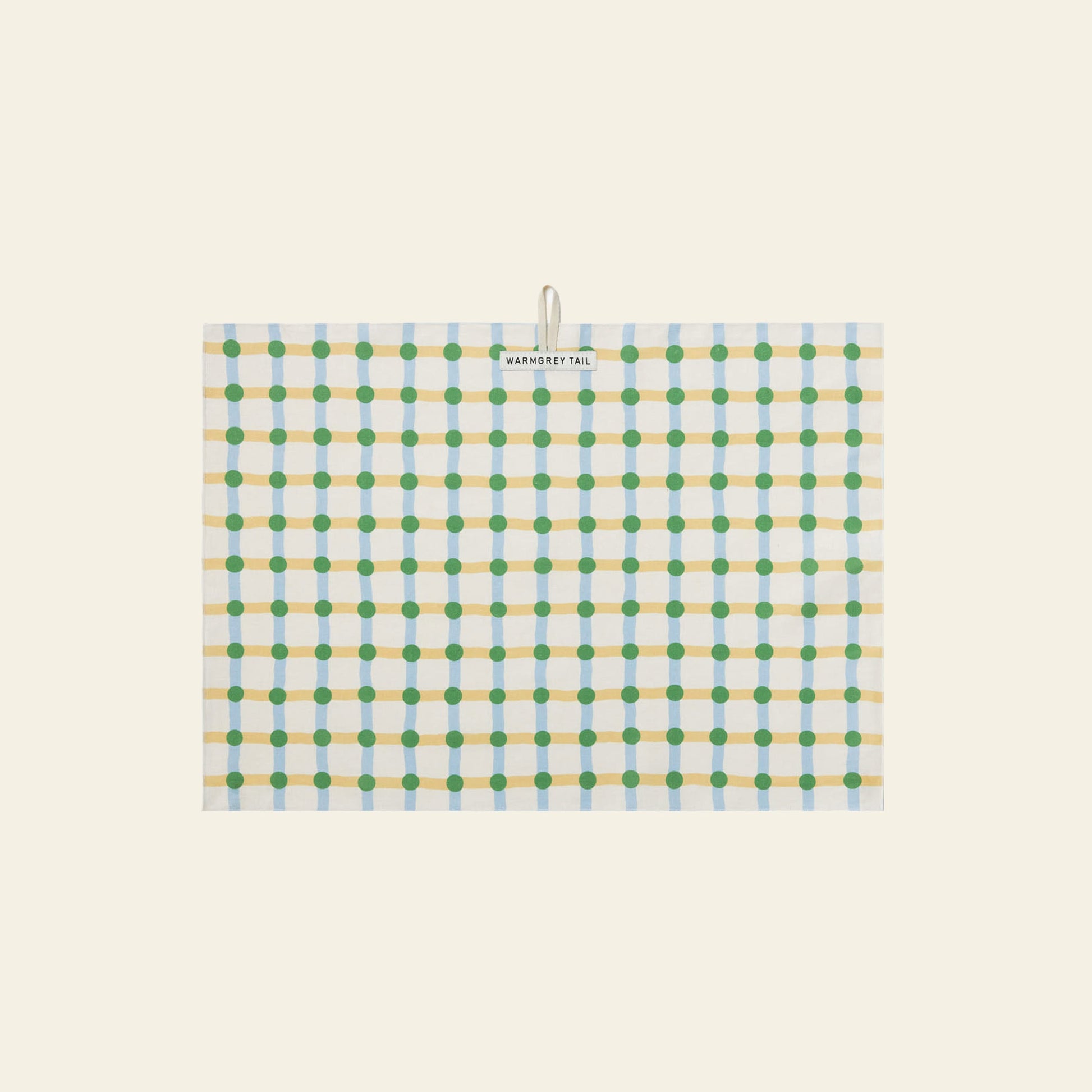 The WARMGREY TAIL Dot Check Kitchen Cloth 2 is a rectangular cream tea towel with yellow, blue, and green grid patterns and dots. Versatile and essential for any kitchen, it comes with a small label at the top center.
